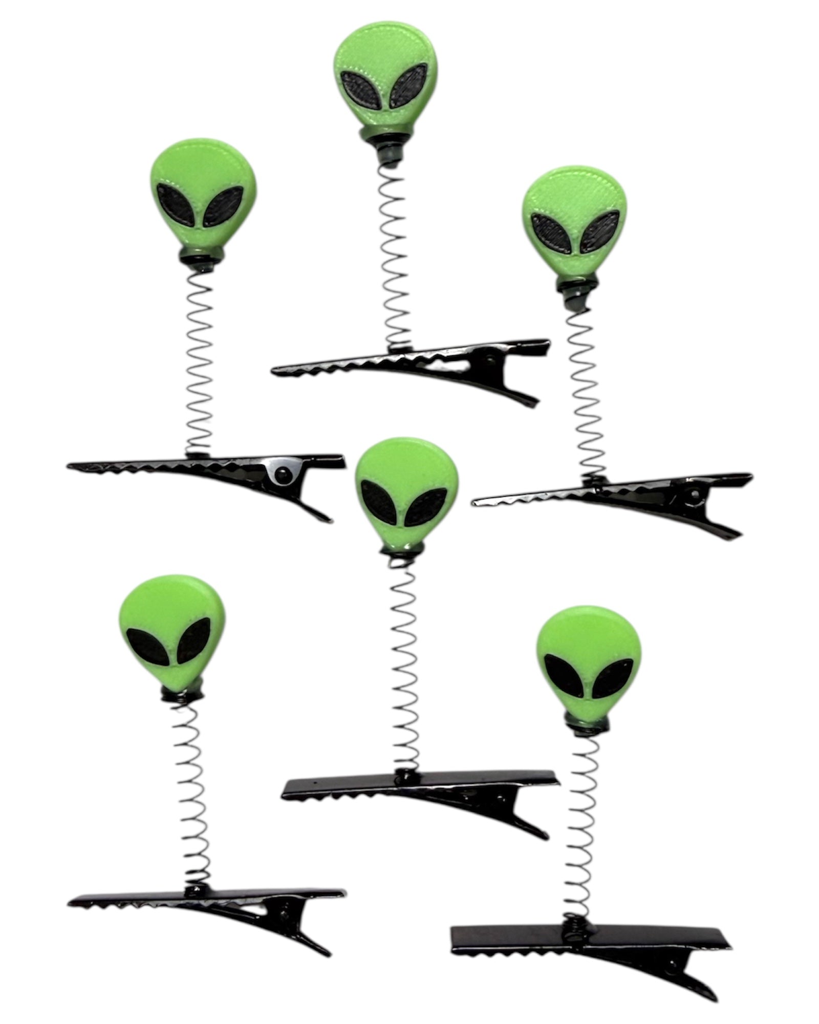 Set of six alien-shaped hair clips with springs on a white background