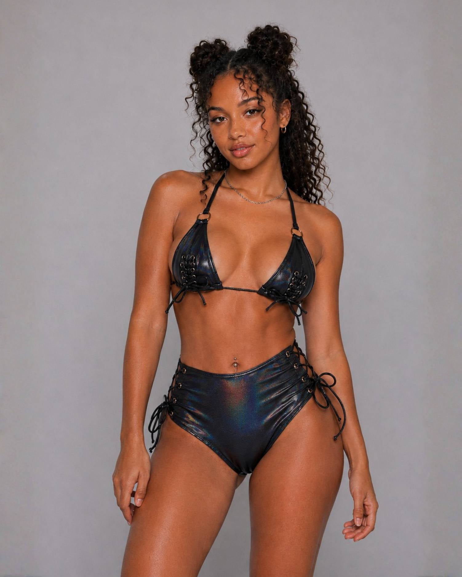 Black shimmer lace-up bikini set with triangle top and high-waisted bottoms, featuring holographic sheen and lace-up sides.