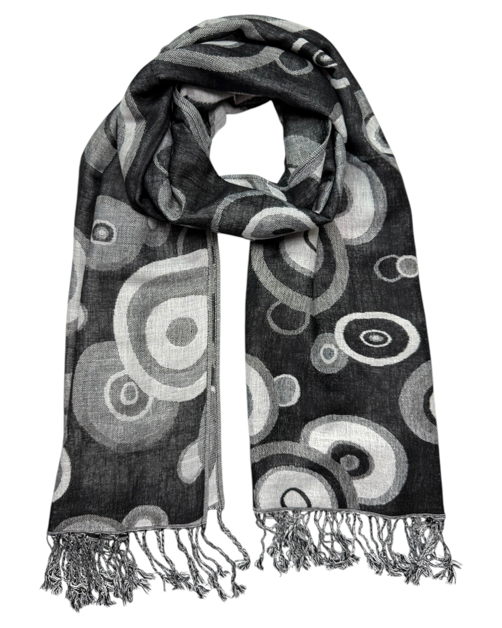 A pashmina scarf with a black and white swirl pattern, displaying a reversible design, with fringes on the ends.
