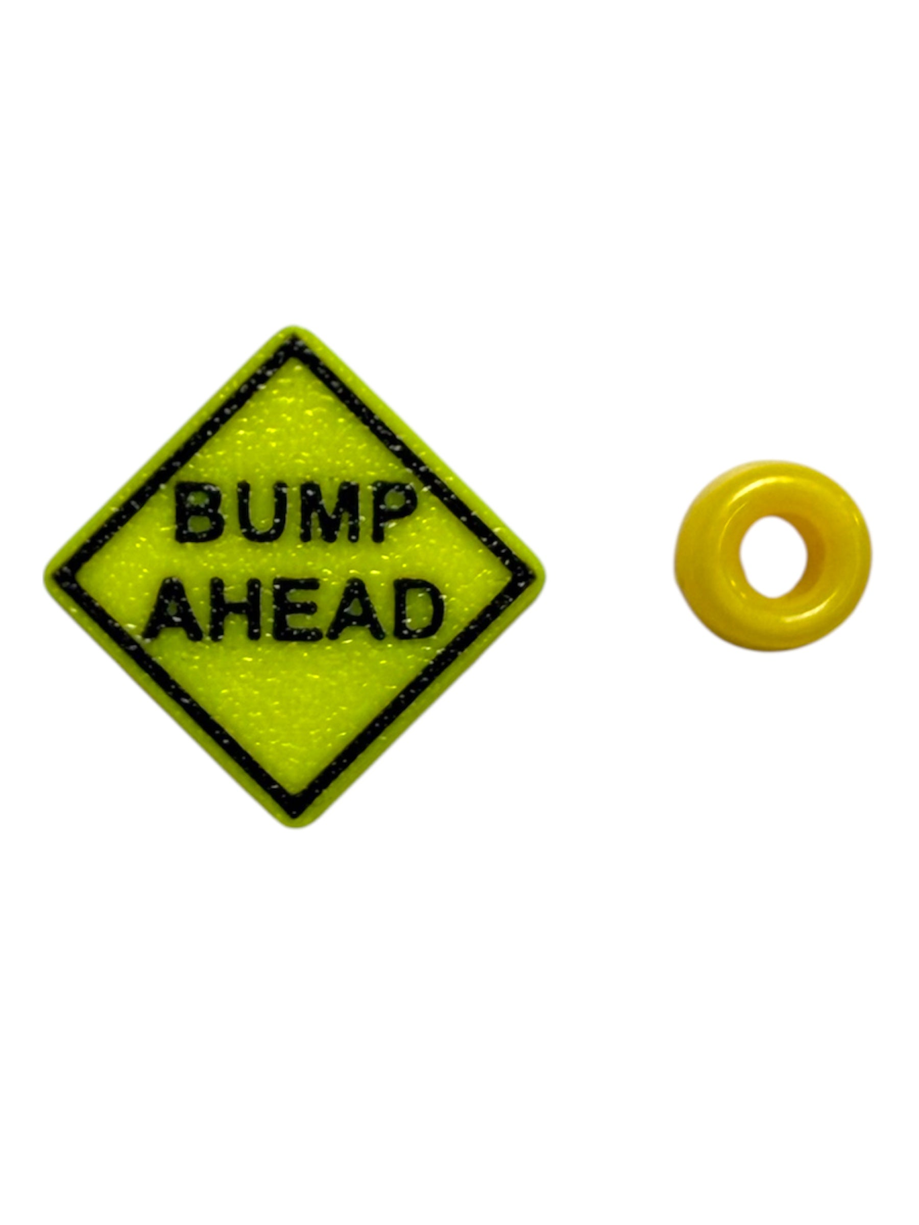 Yellow 'Bump Ahead' sign kandi beads with a small yellow circle on a white background