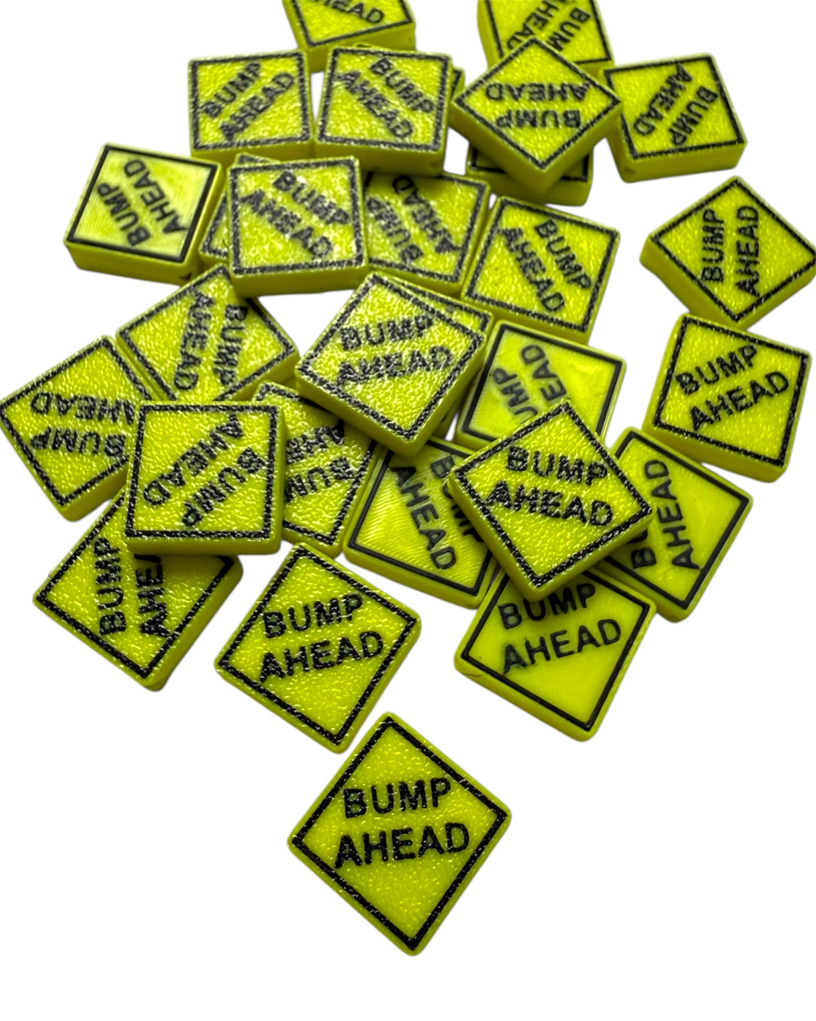 Multiple yellow kandi beads with 'Bump Ahead' text on a white background