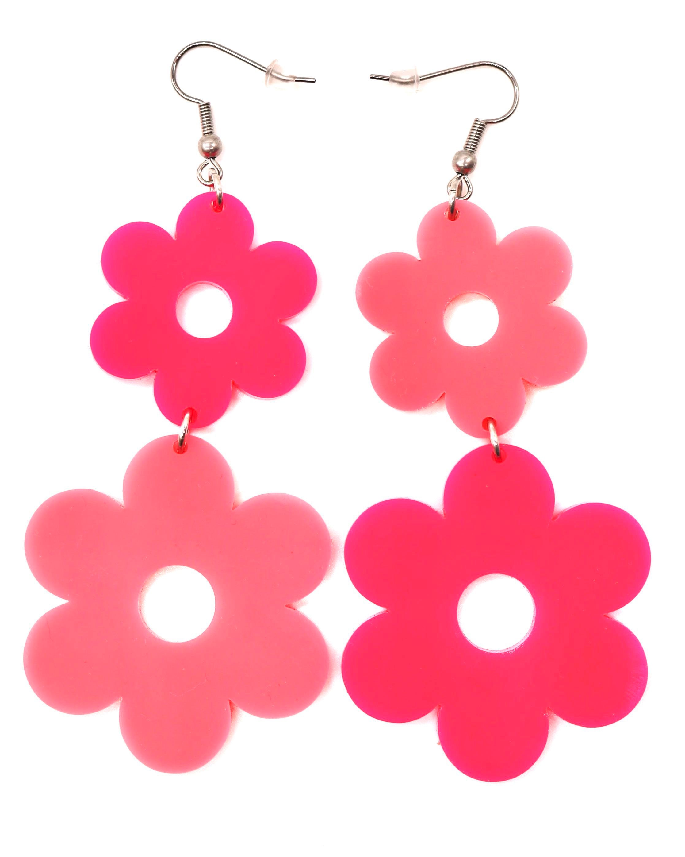 A pair of Flower Power Earrings with alternating pink colored flowers, featuring a smaller flower on top and a larger flower on the bottom.