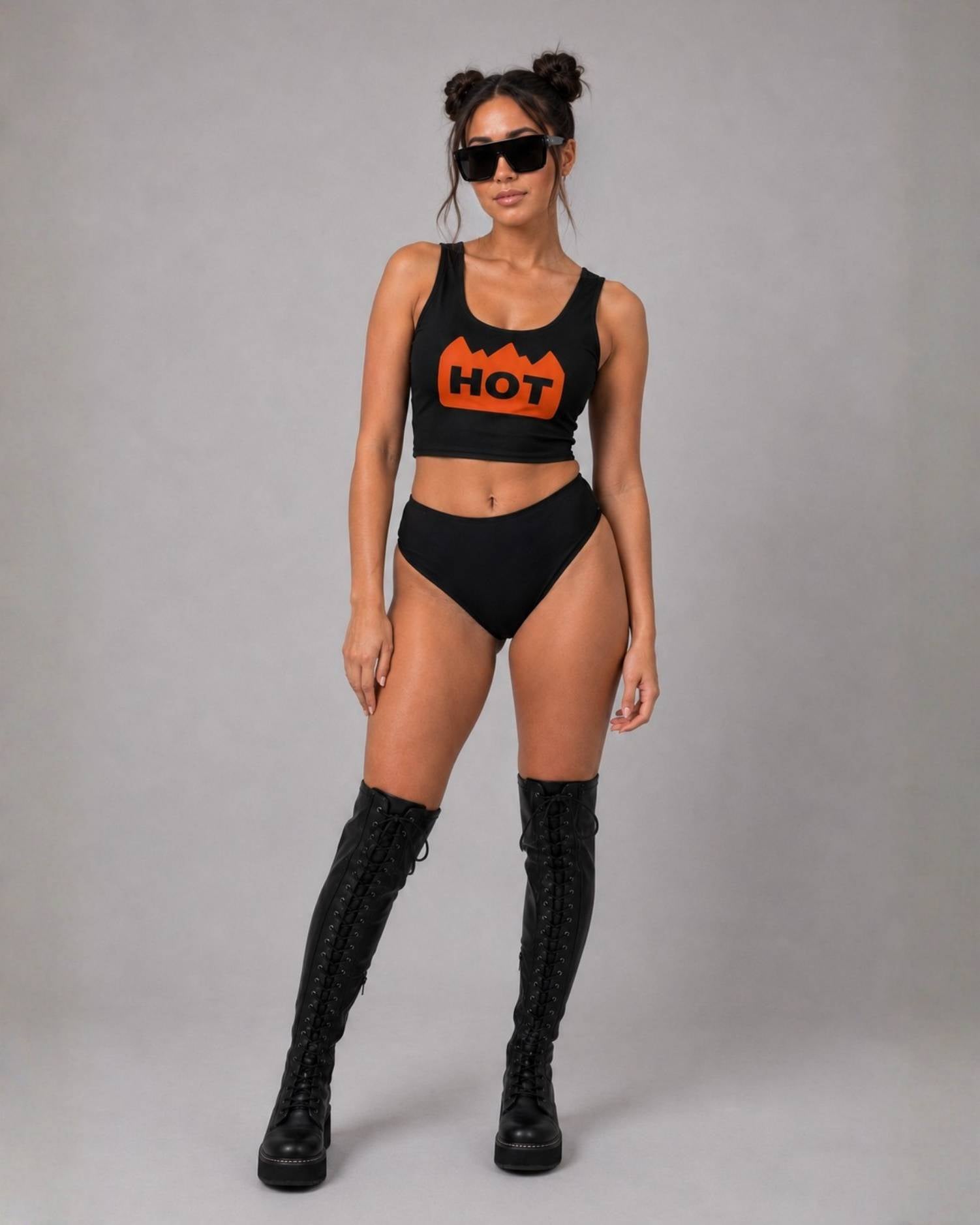 Black crop top with orange "HOT" flame graphic, paired with matching high-waisted bottoms and thigh-high boots.