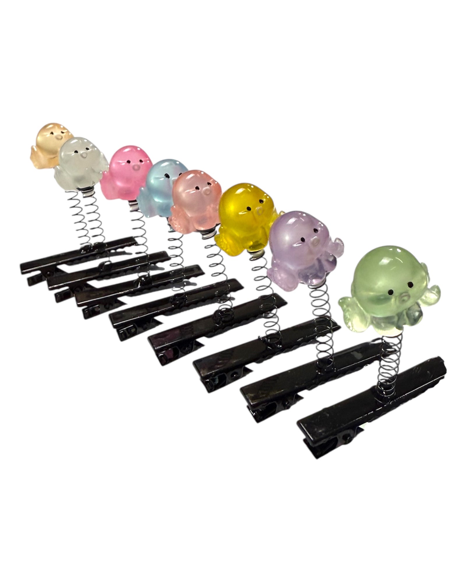 Set of black clothespins with colorful springy octopus ends on a white background