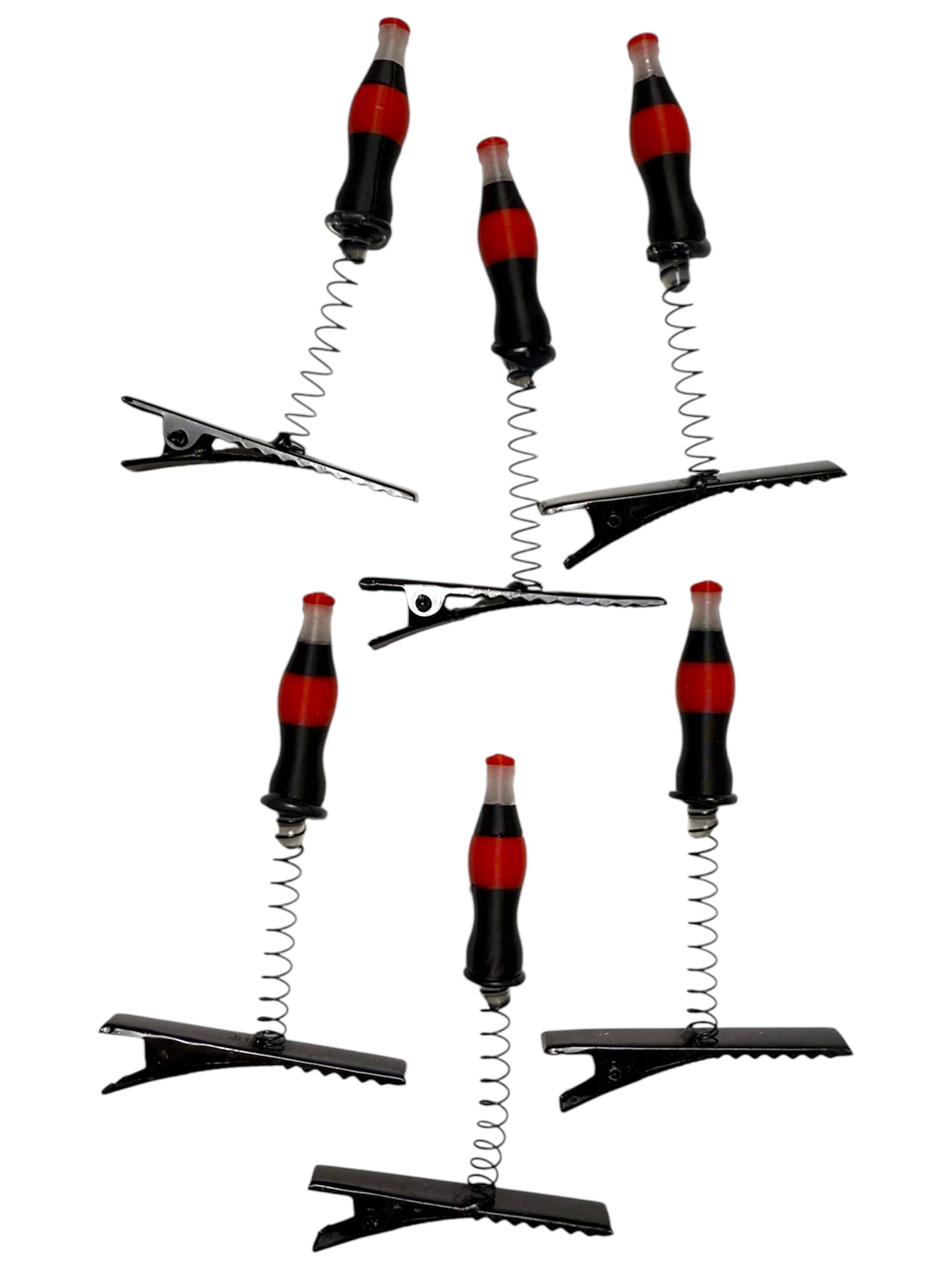 Set of hair clips with Coca-Cola bottle design on a white background