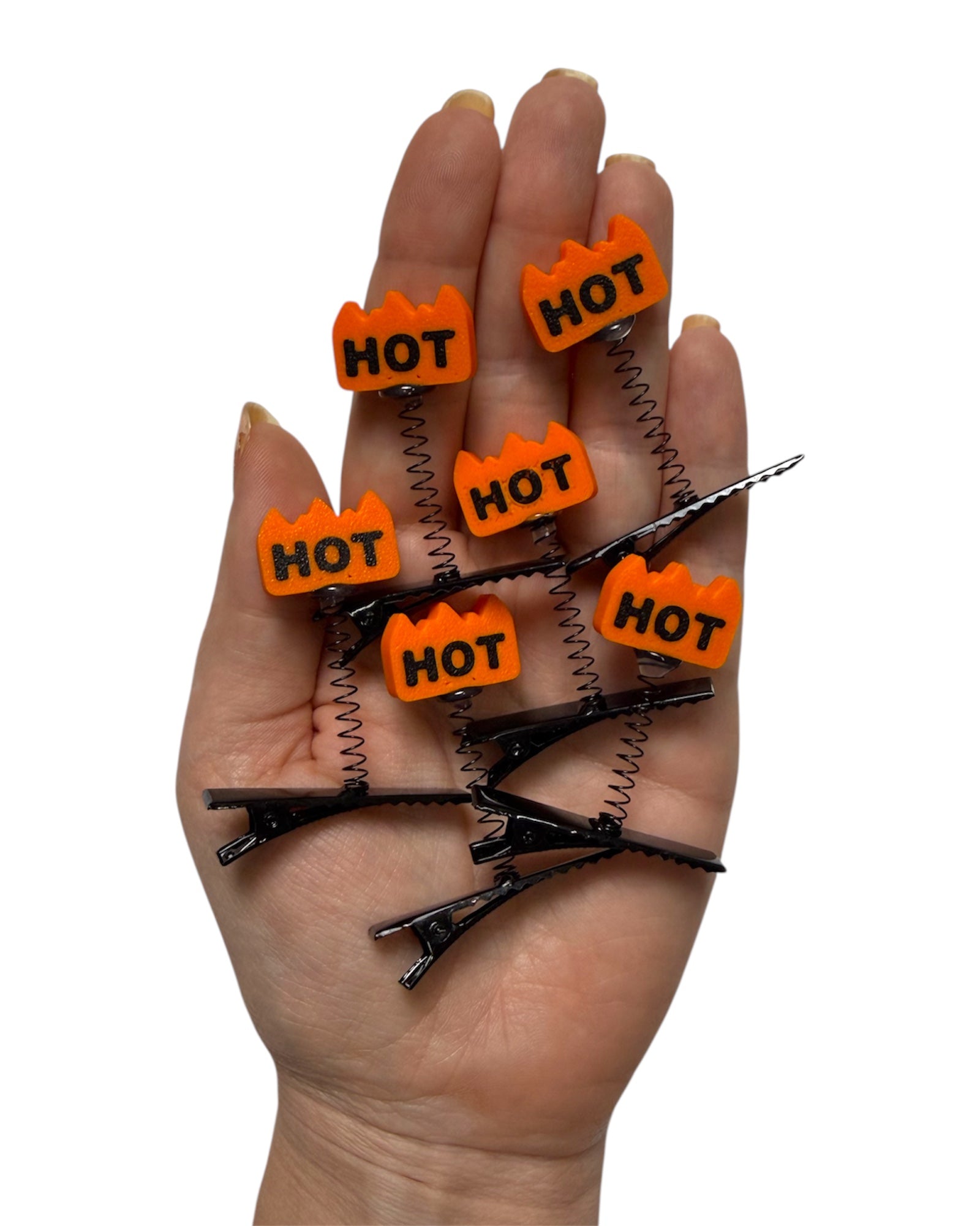 Hand holding multiple sprout clips with 'HOT' labels on a white background