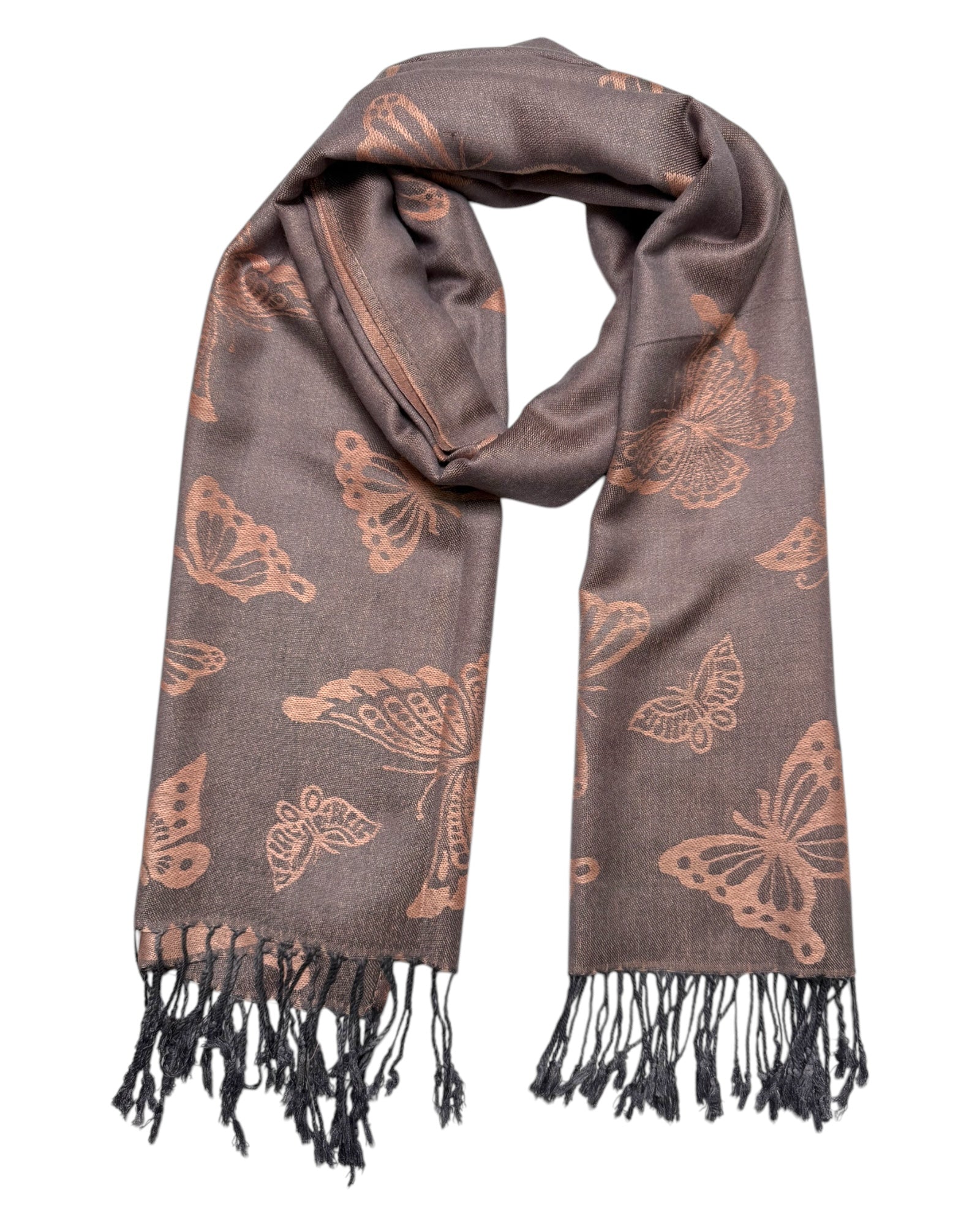 A scarf with a reversible design featuring butterfly patterns on a rose gold and grey background with fringe trim.