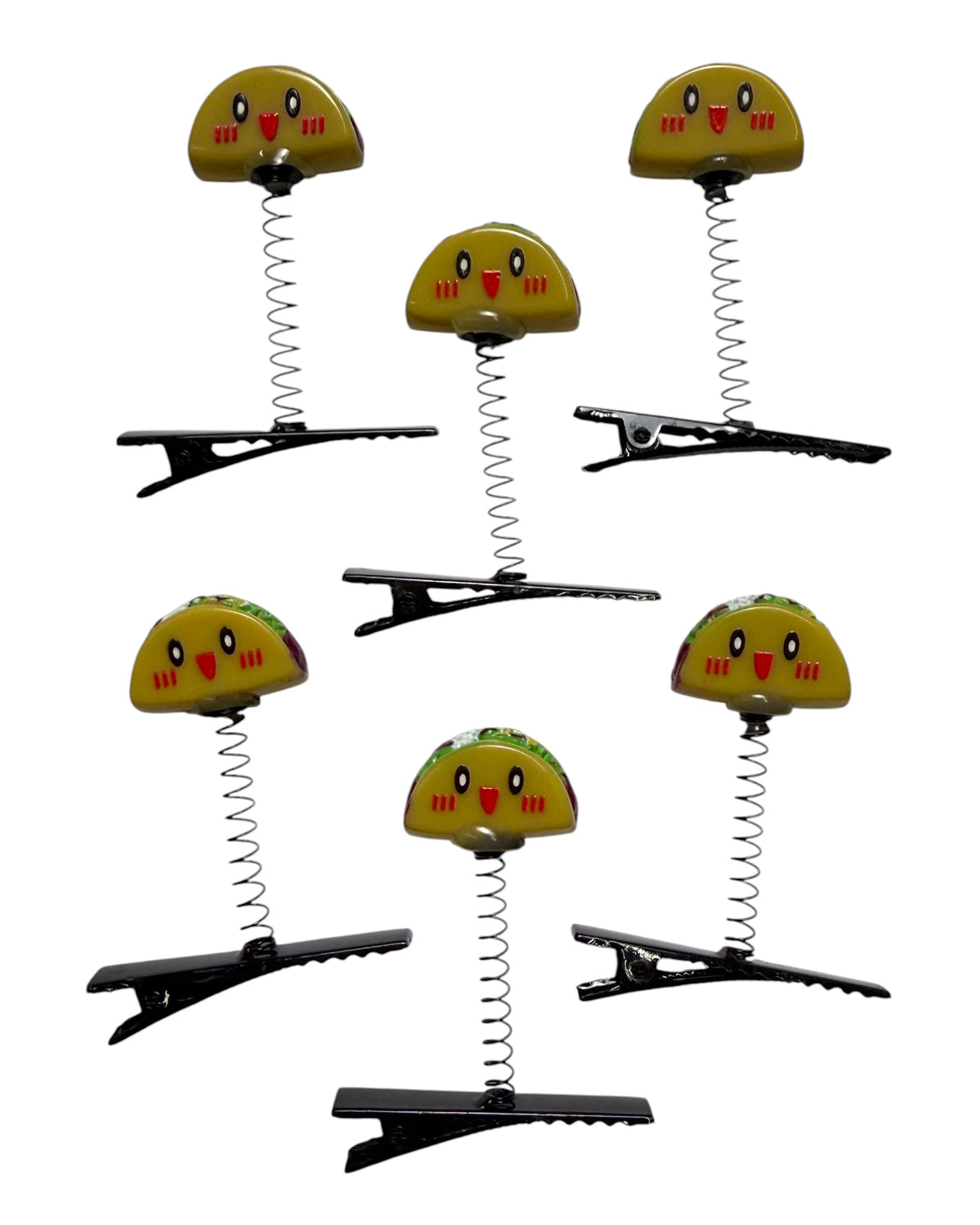 Six yellow spring-loaded hair clips shaped like smiling cartoon tacos, arranged on a plain white background.