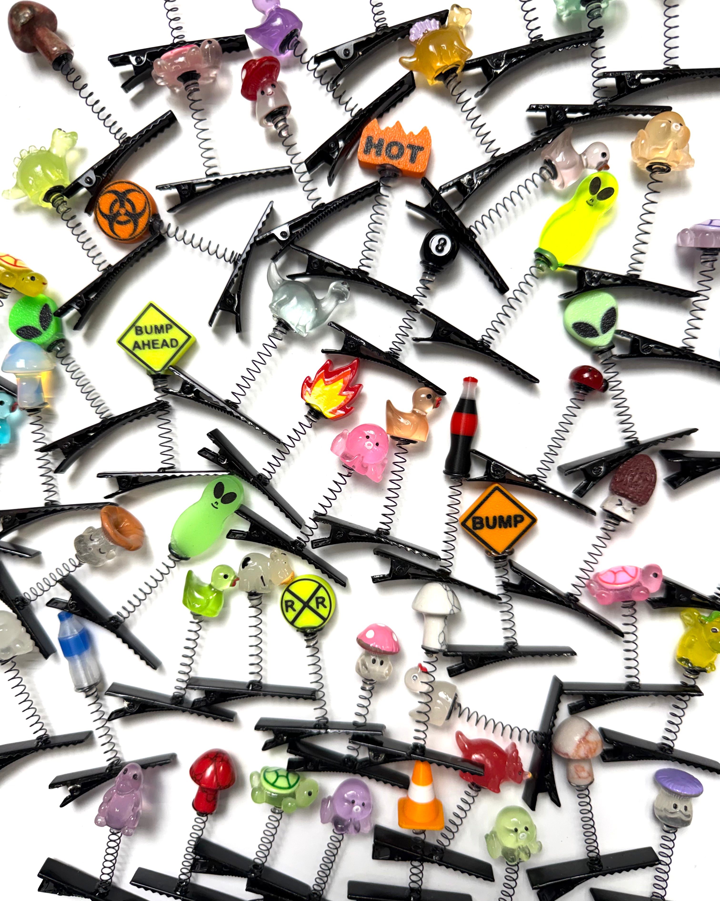 Collection of rave sprout hair clips with various designs on a white background