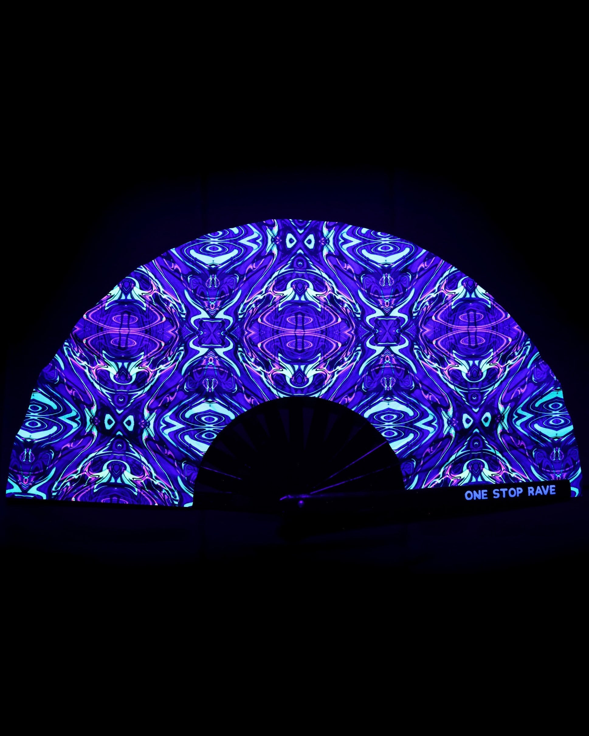 Acid Melt festival hand fan with UV-reactive artwork under blacklight.