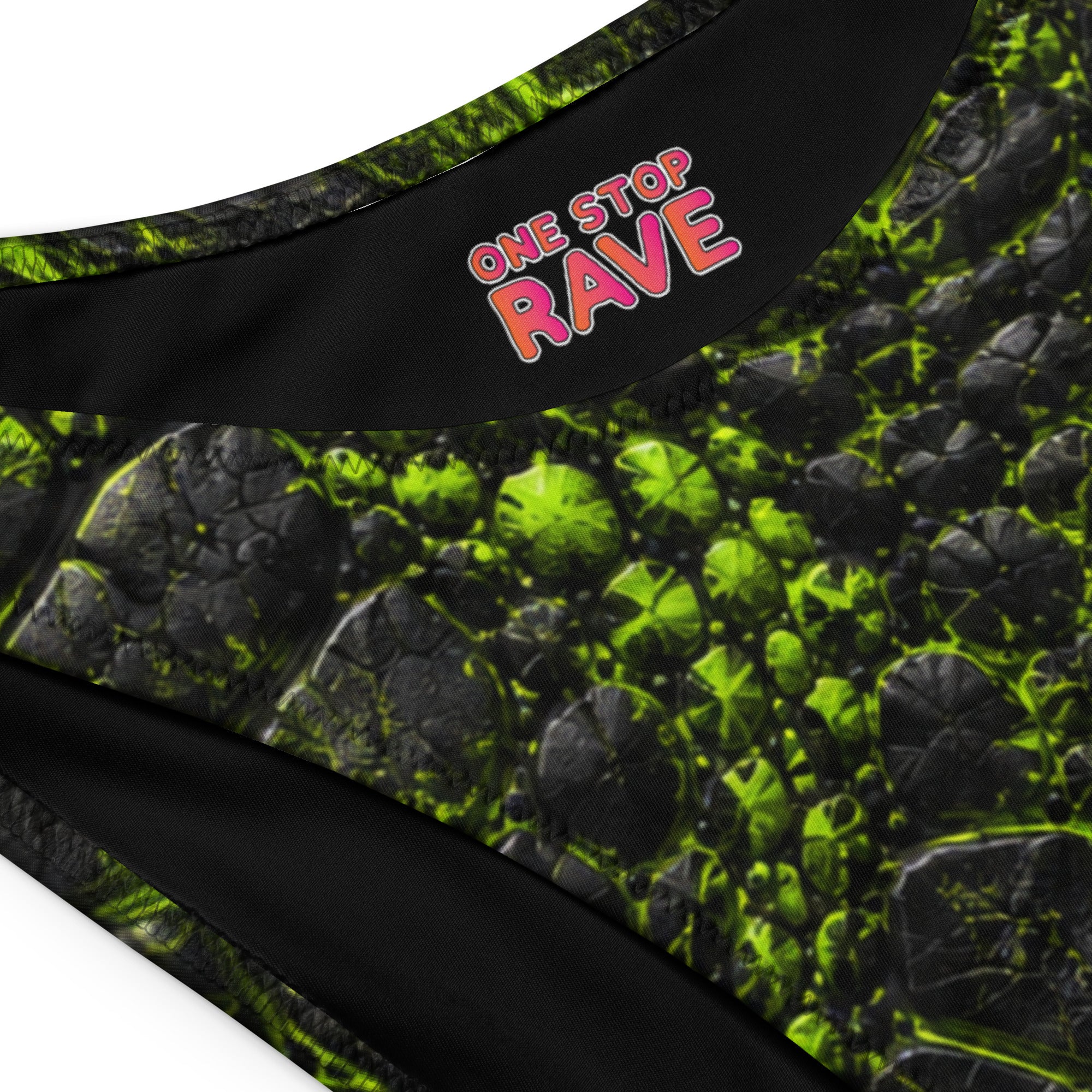 Close-up of black and neon green cracked-texture V-cut bikini bottom with One Stop Rave logo on the waistband.