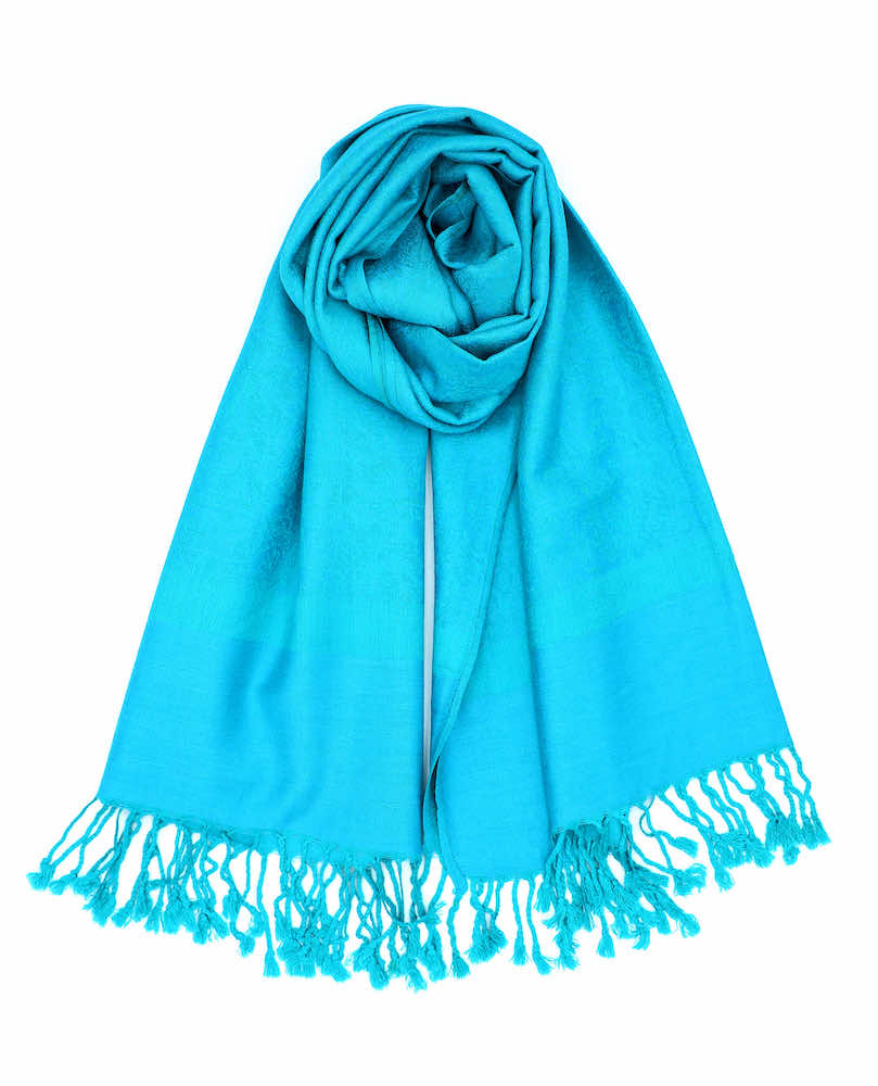 A blue pashmina with paisley patterns draped around, showing off its length and the fringed ends.