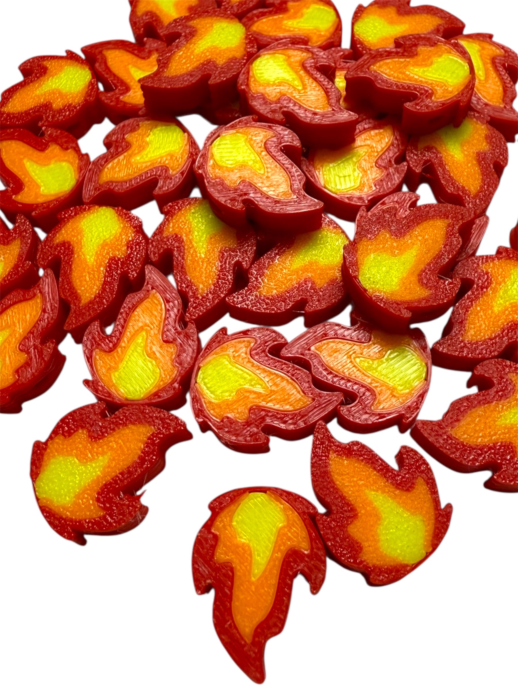 Close-up of Fire Kandi Rave Beads with red flame edges and yellow centers, handmade for kandi bracelet making.