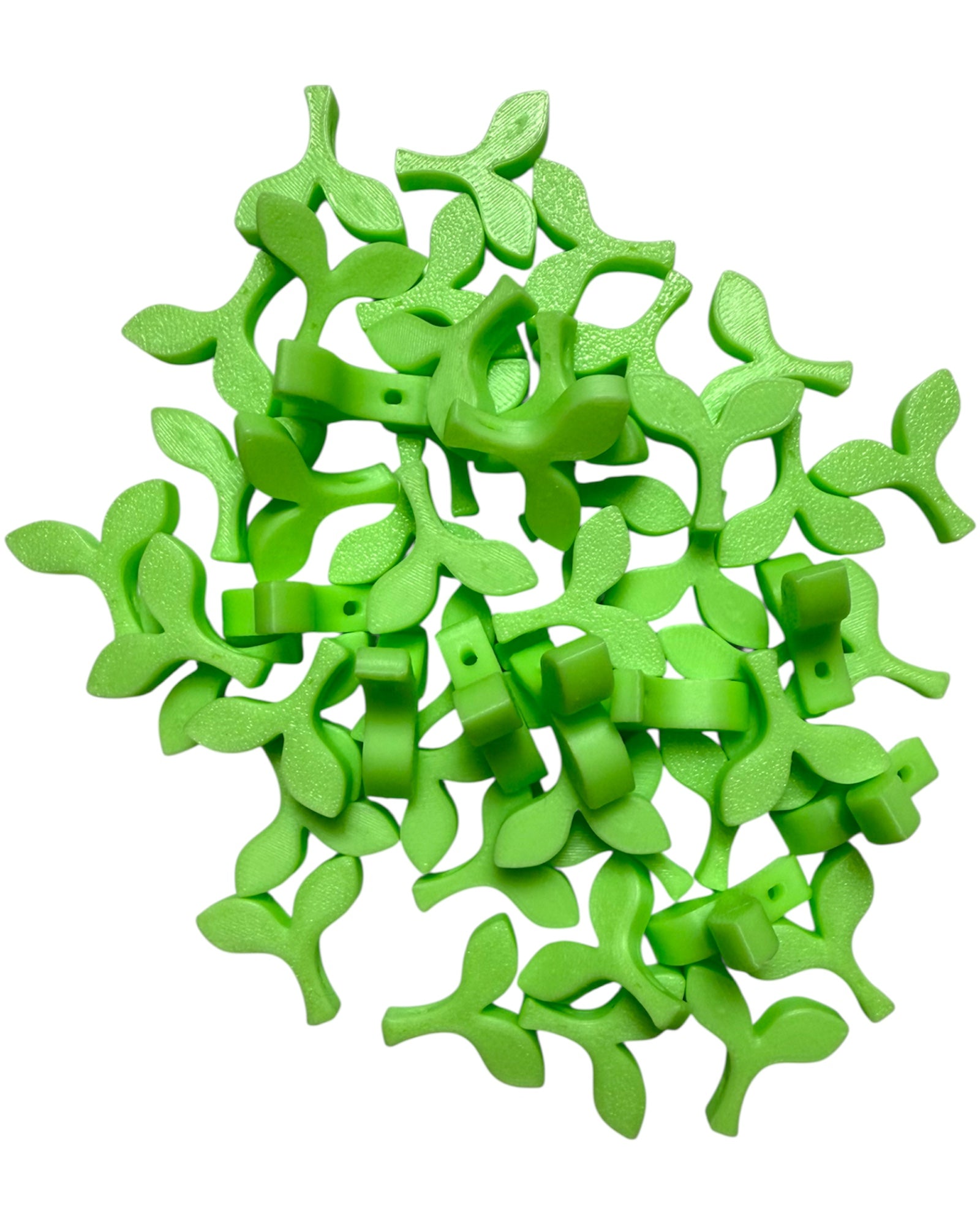 Close-up of glow-in-the-dark sprout kandi beads with bead holes visible, designed for kandi bracelets and rave jewelry making.