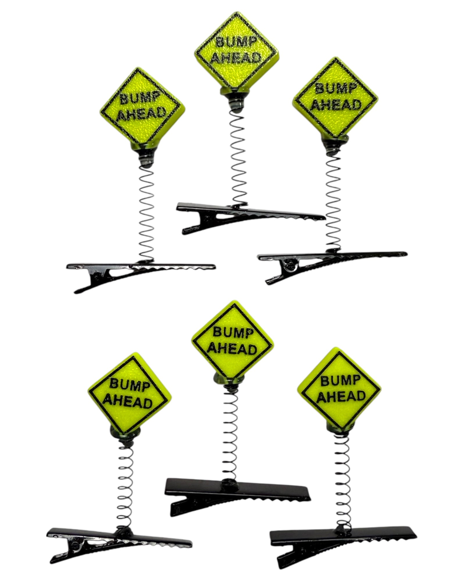 Set of hair clips with 'Bump Ahead' sign design on a white background