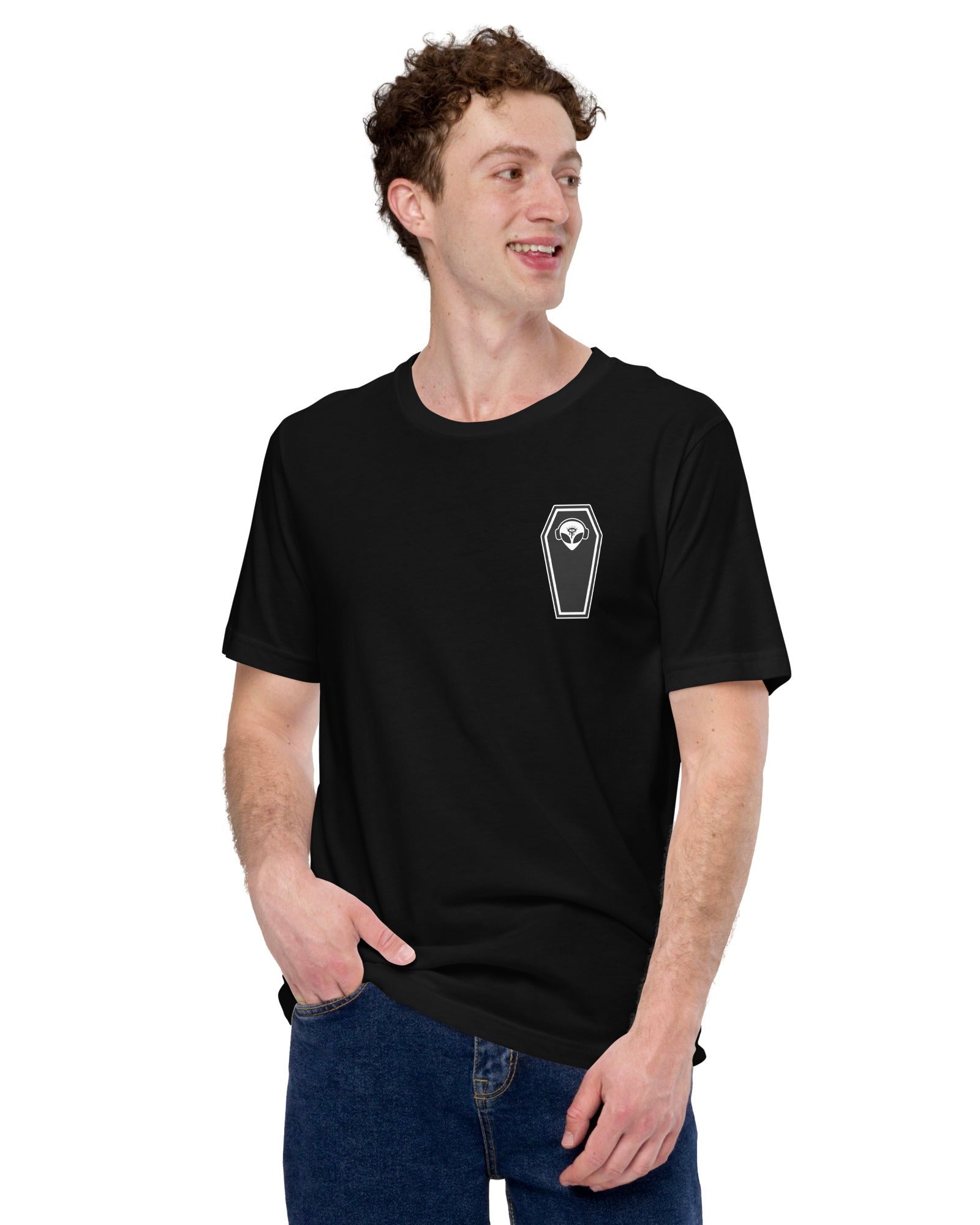 The front side of the model wearing a black t-shirt with an alien head in a coffin over the left chest.