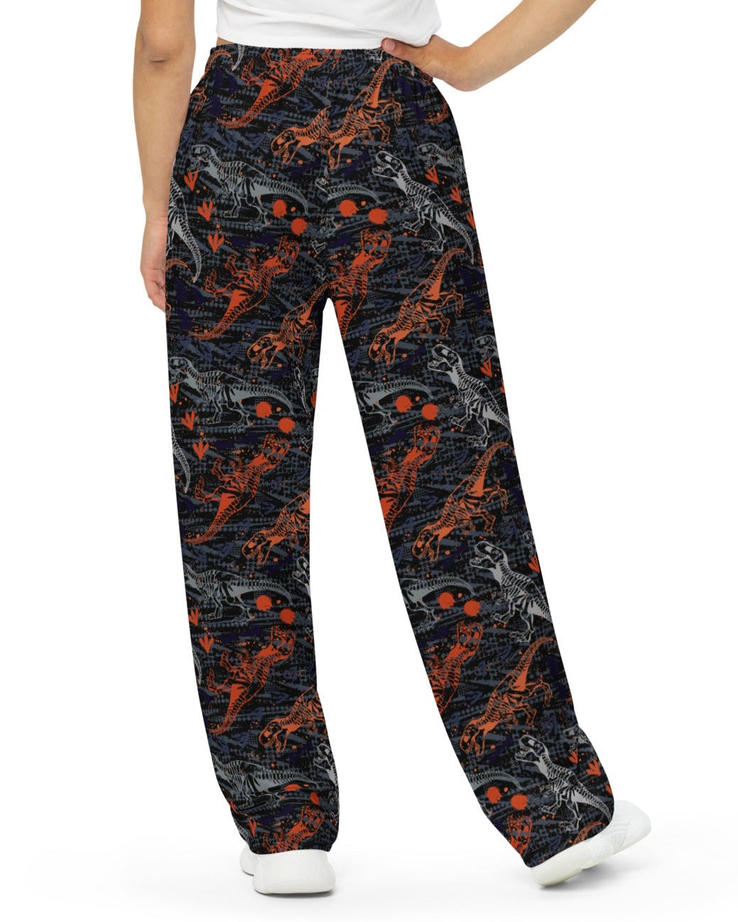 Back view of model rocking One Stop Rave's T-Wrecked Wide Leg Pants with a distinct dinosaur print.