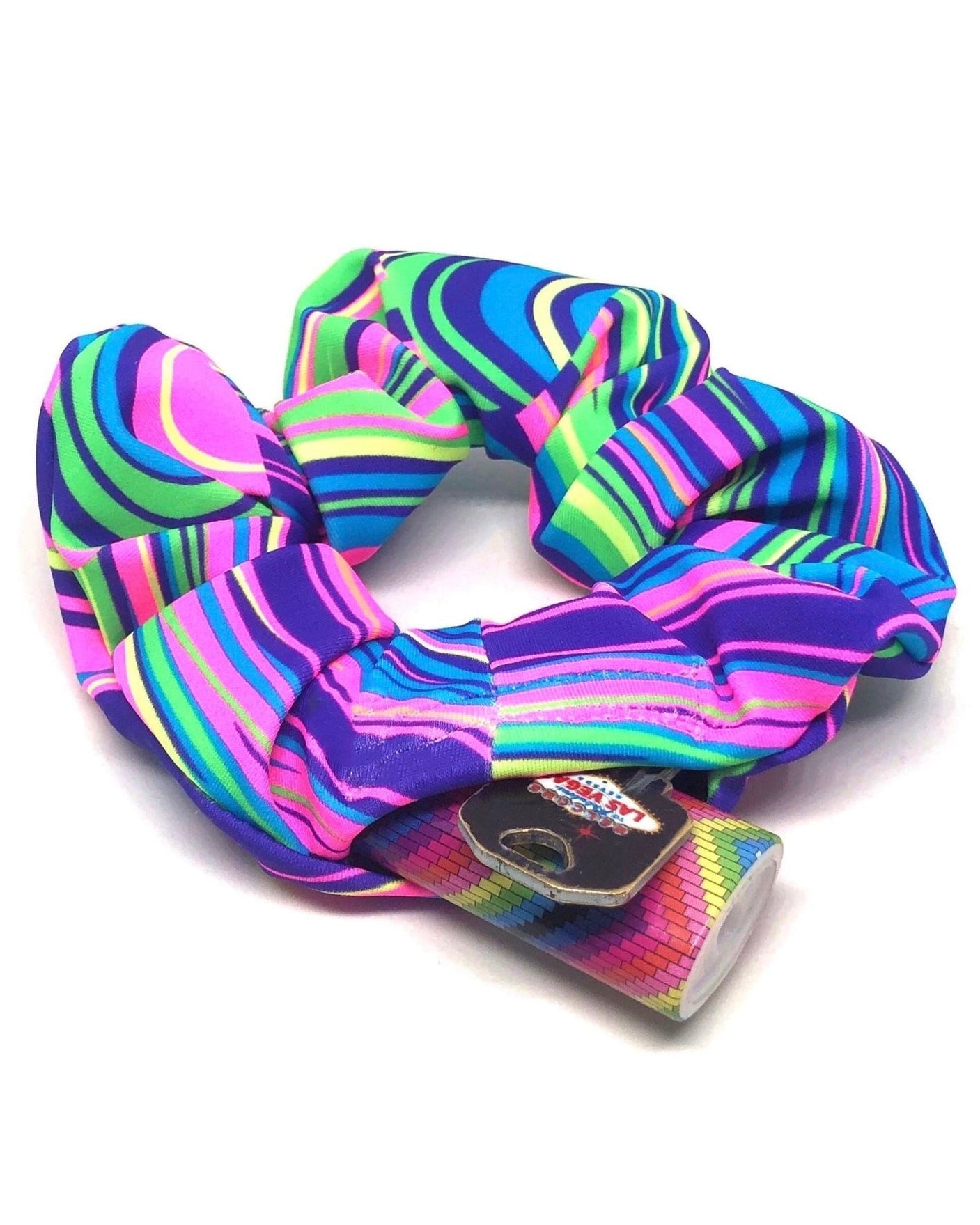 The Kandi Flip Stashie glowing under blacklight, showcasing its neon pink, green, and blue swirls. - one stop rave.