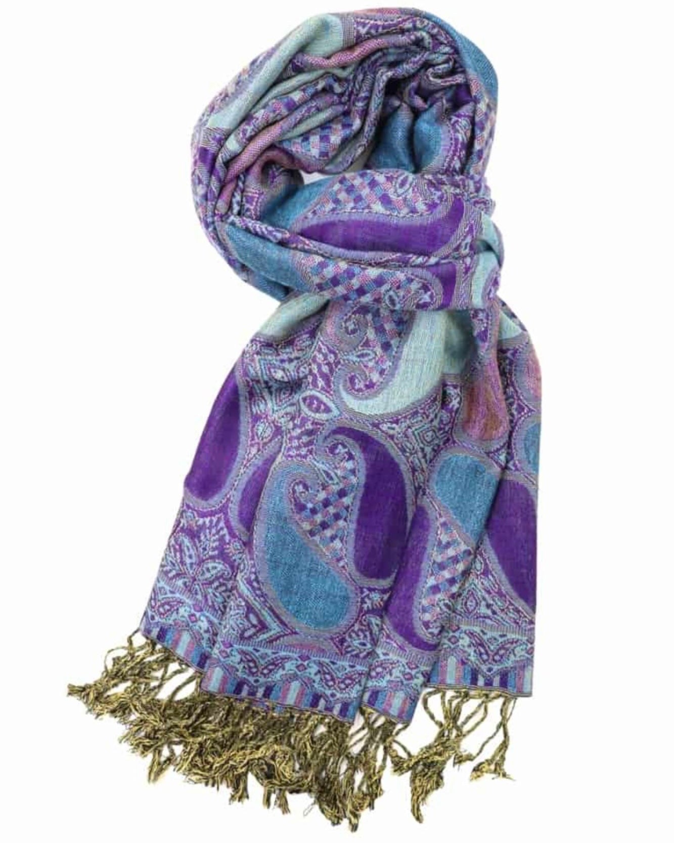 A purple and blue paisley pattern pashmina with fringes displayed on a white background.