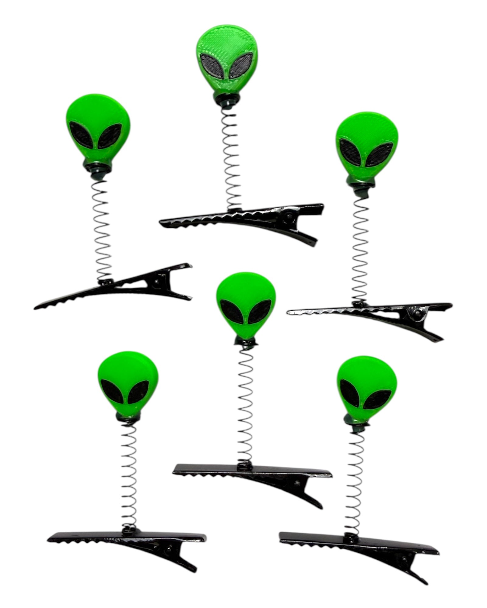 Set of six alien-shaped hair clips with springs on a white background