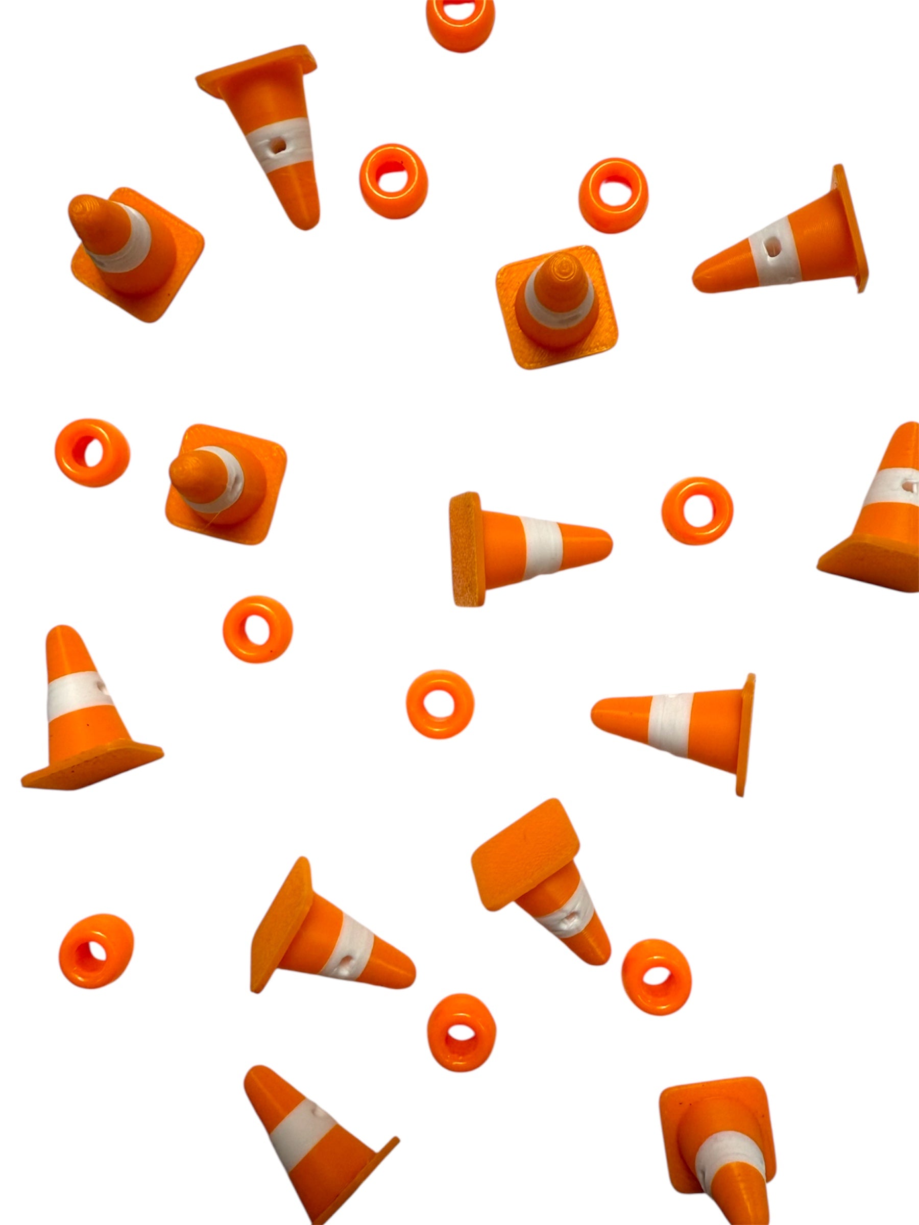Orange traffic cone kandi beads with white stripes scattered amongst pony beads on a white background