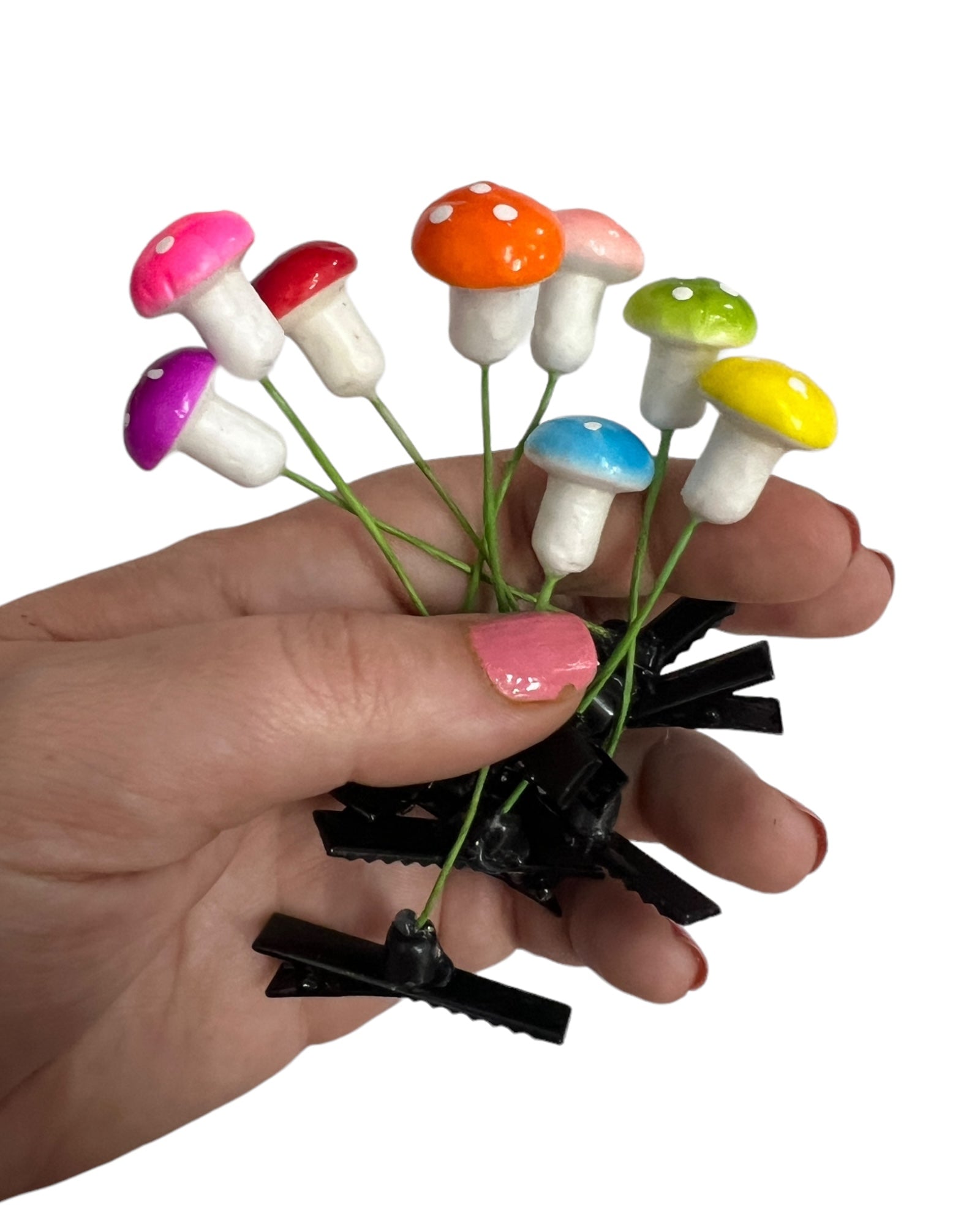 8-pc set colorful mushroom sprout clip set held in a hand. 
