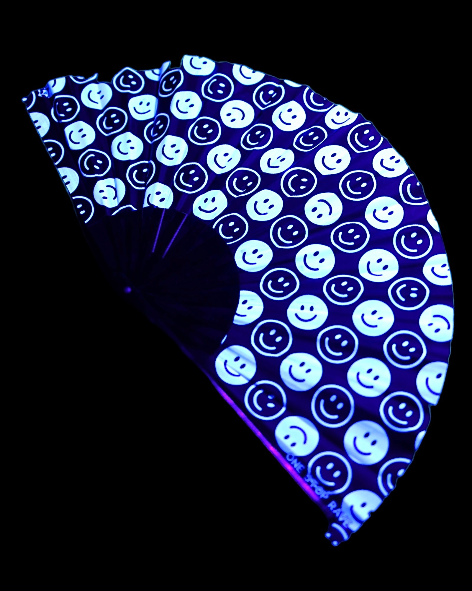 All Smiles hand fan lit up under blacklight purple glow.