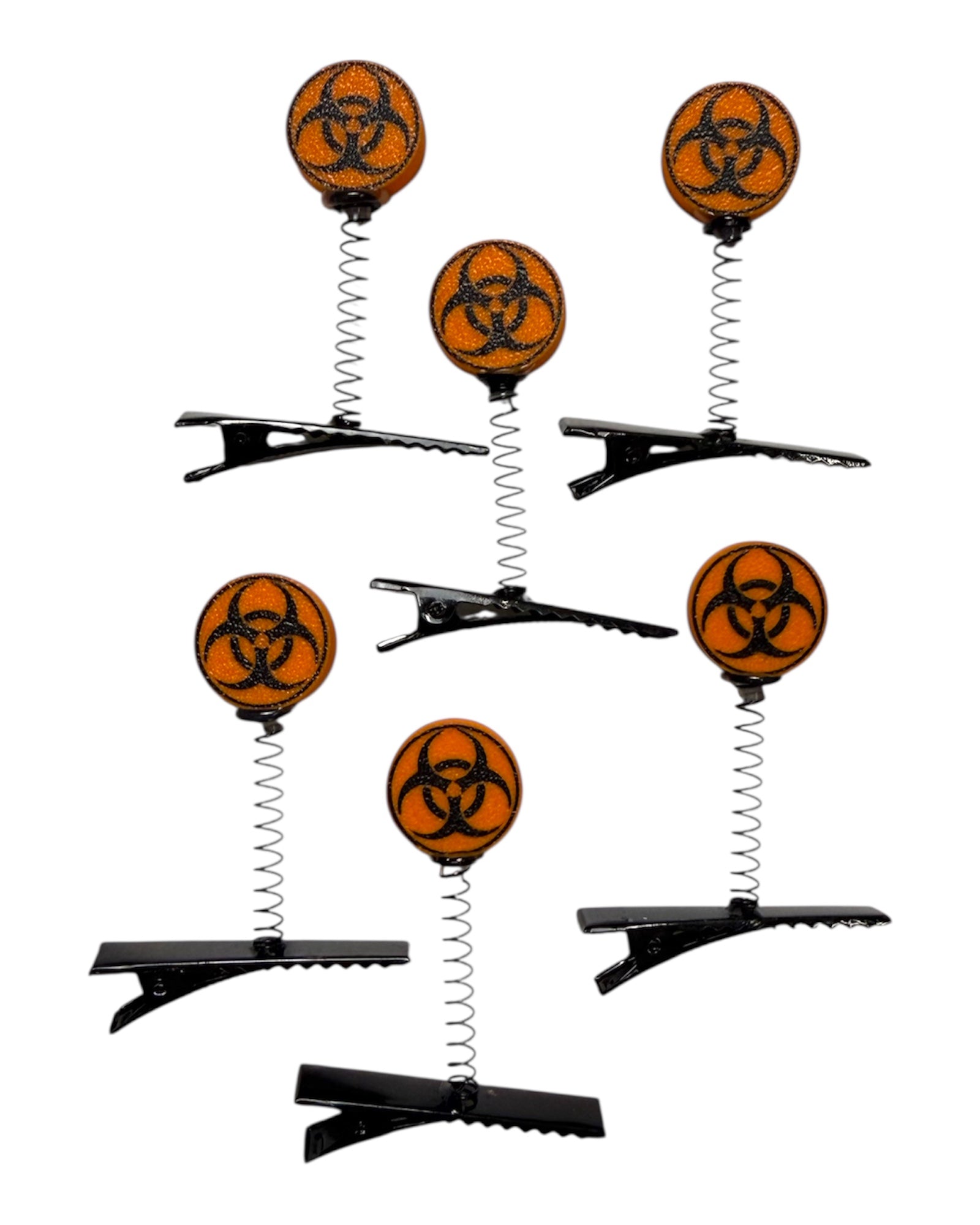 Set of hair clips with biohazard symbol on a white background