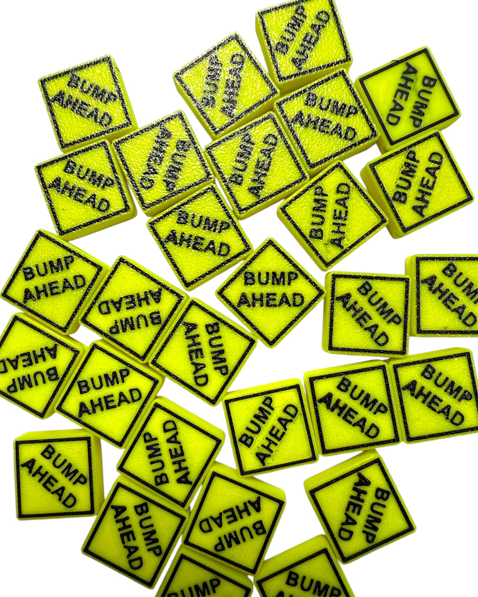 Multiple yellow 'Bump Ahead' signs kandi beads on a white background