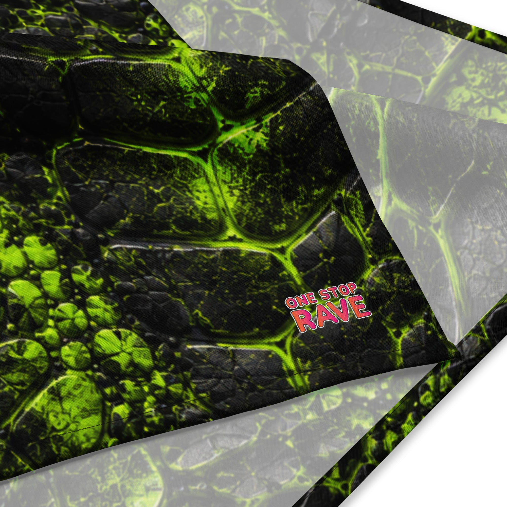 Close-up of the Ravage Bandana showing black and neon green cracked prehistoric texture with the One Stop Rave logo.
