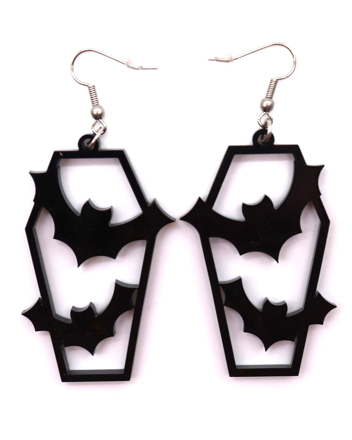 Black coffin-shaped earrings with cut-out bat design on a white background
