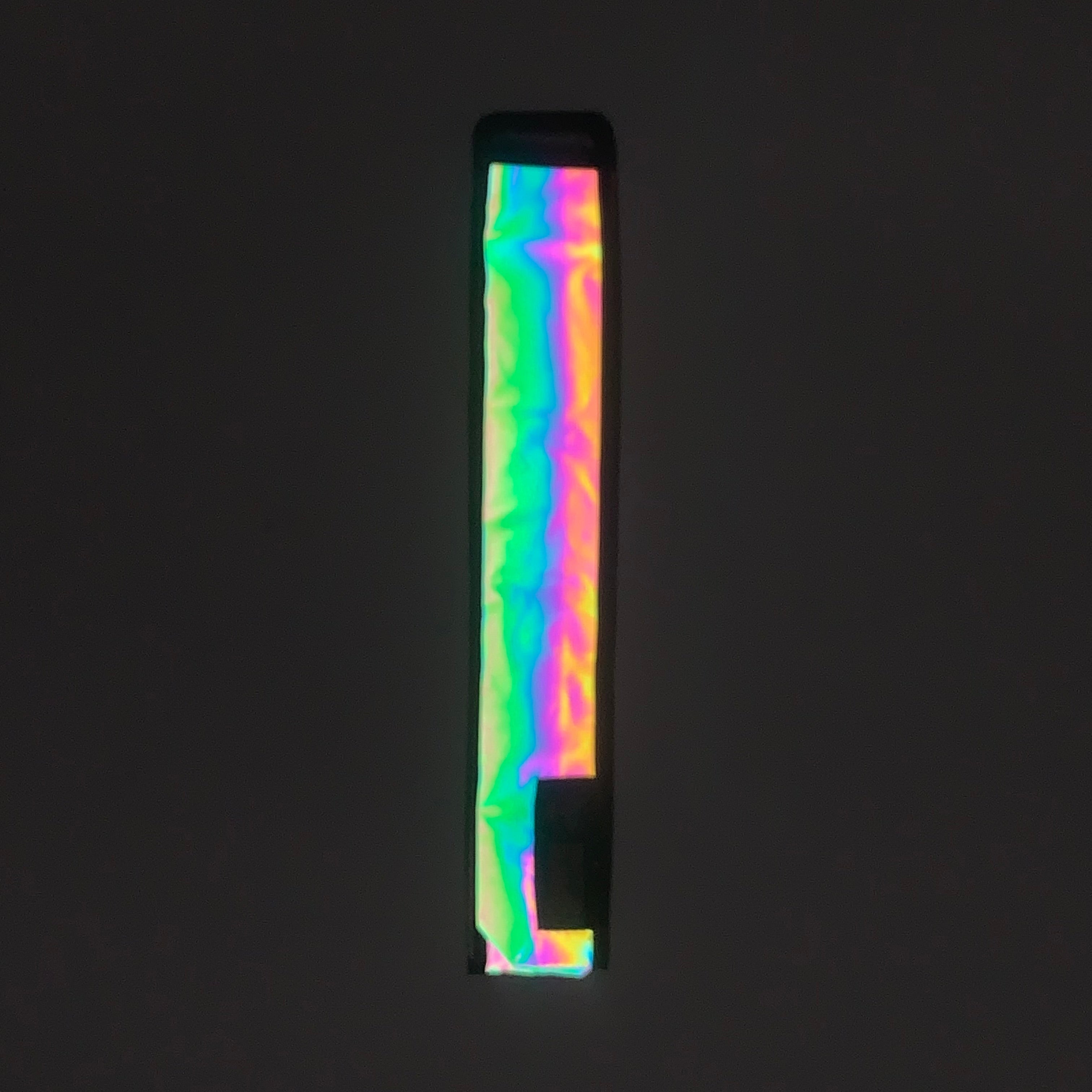 Flash reflective fan holster showing rainbow reflection.