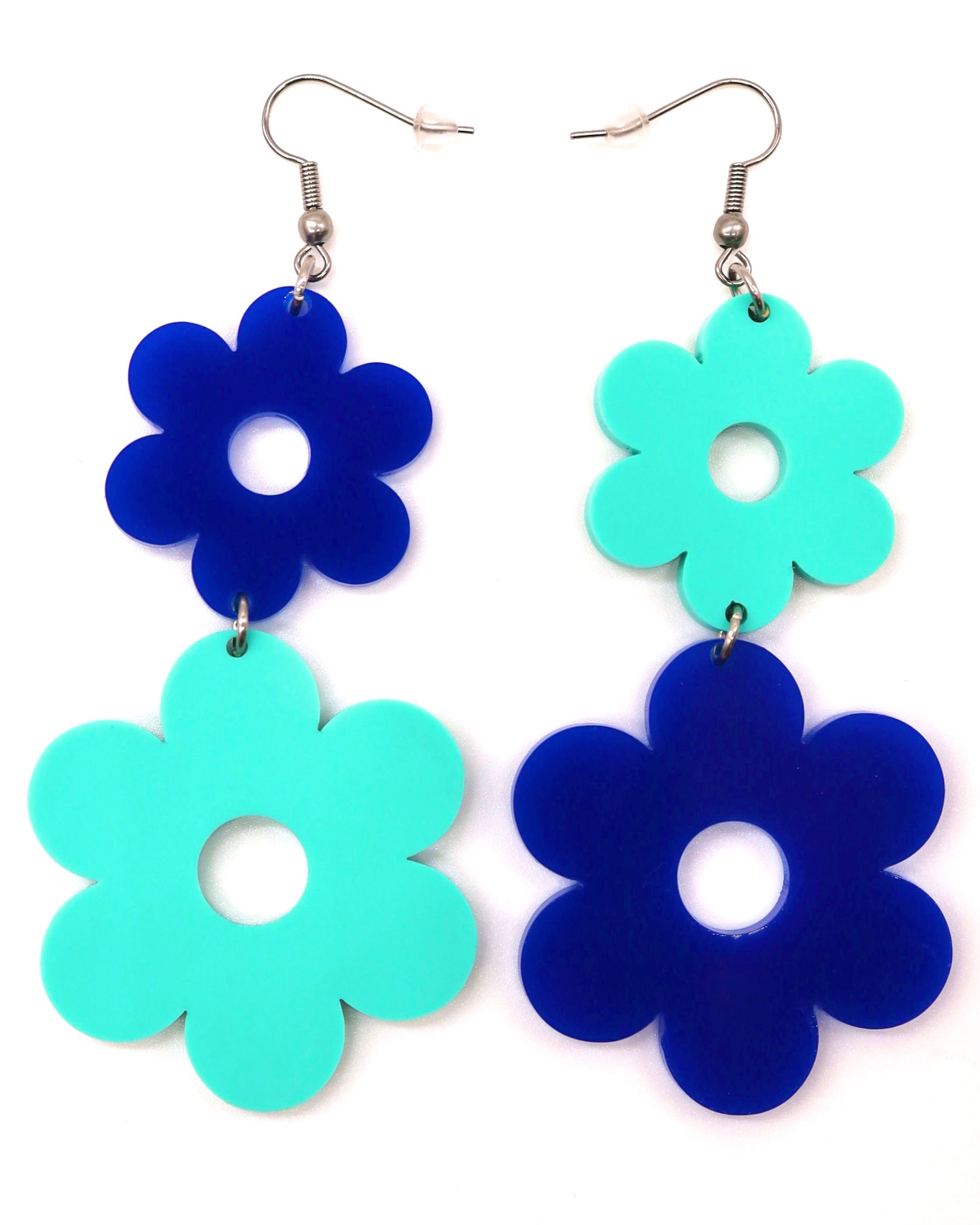 A pair of Flower Power Earrings with alternating blue colored flowers, showcasing a smaller flower on top and a larger flower on the bottom.