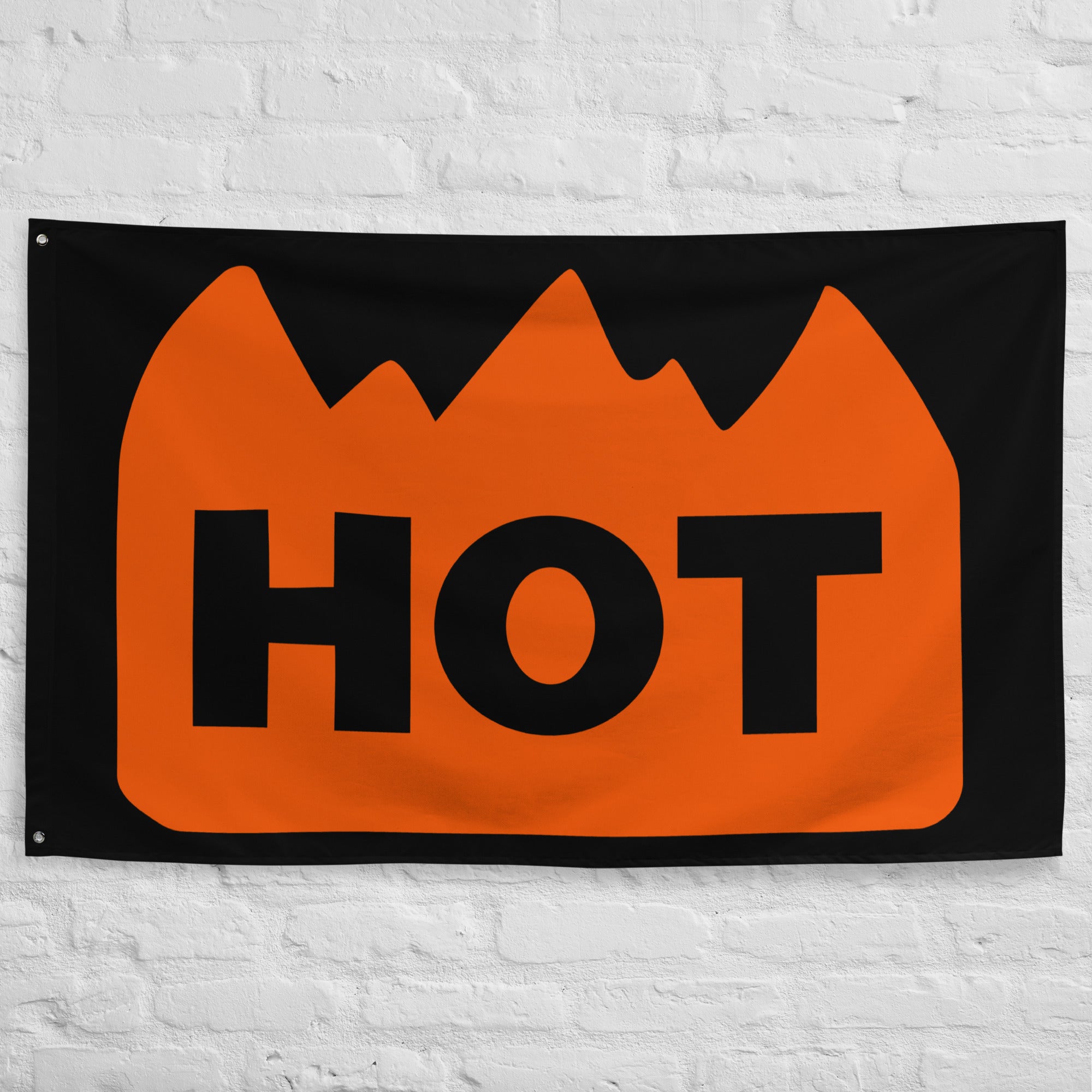 Hot Sticker Festival Flag hanging on a brick wall.