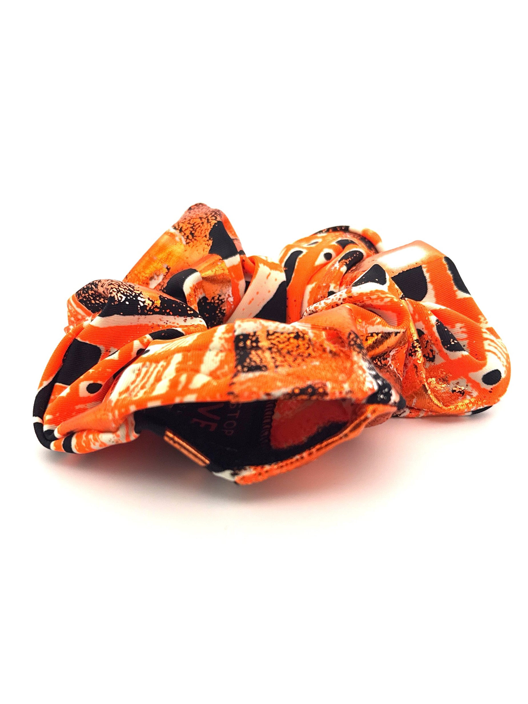 Orange and black patterned hair scrunchie on a white background