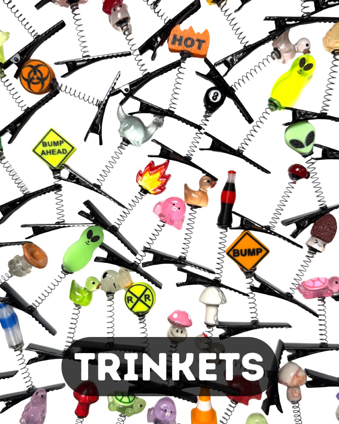 Assorted rave sprout clips with colorful novelty charms including aliens, mushrooms, signs, animals, flames, and symbols on black alligator clips.