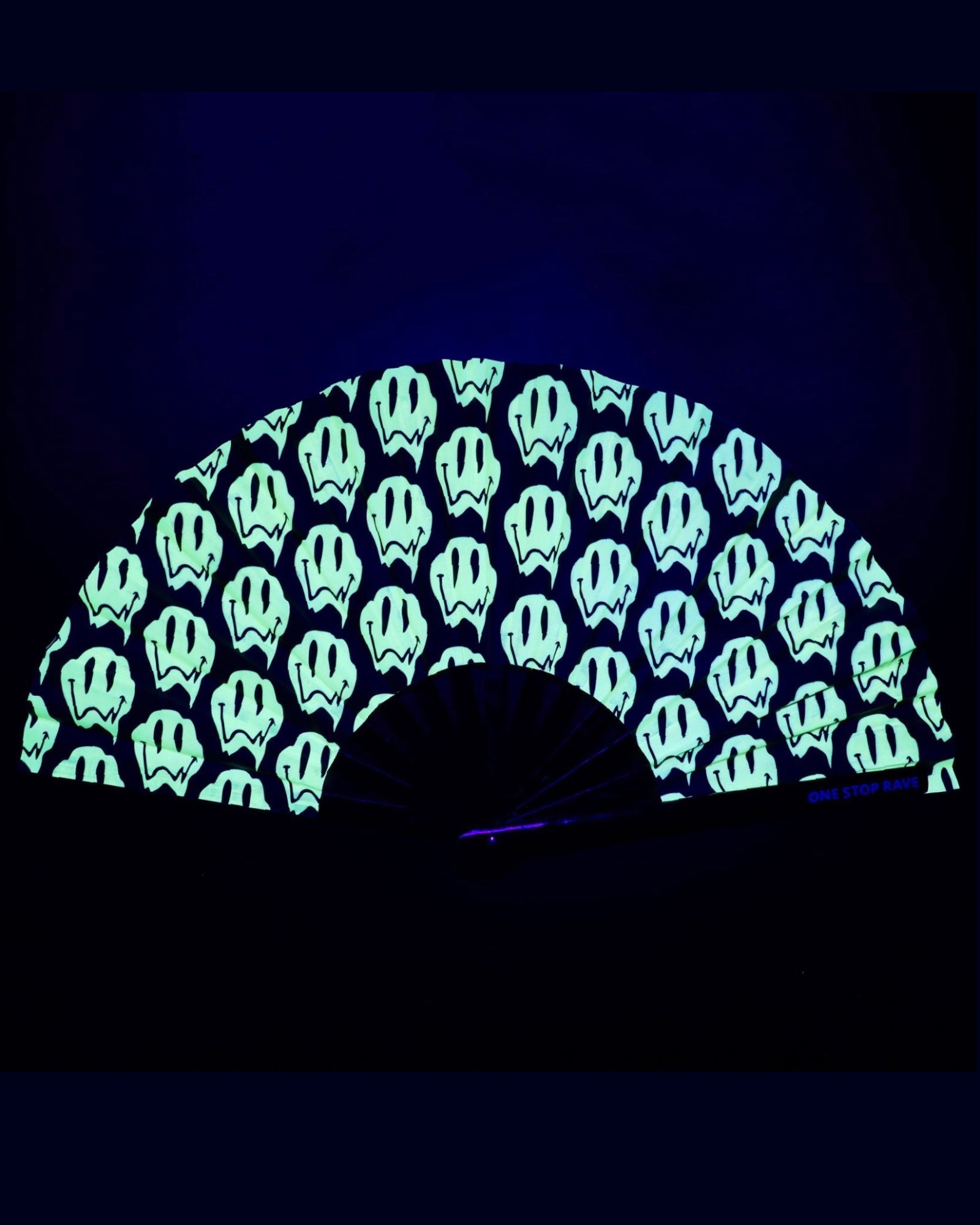 Stay Trippy hand fan glowing electric green under blacklight UV-Reactive