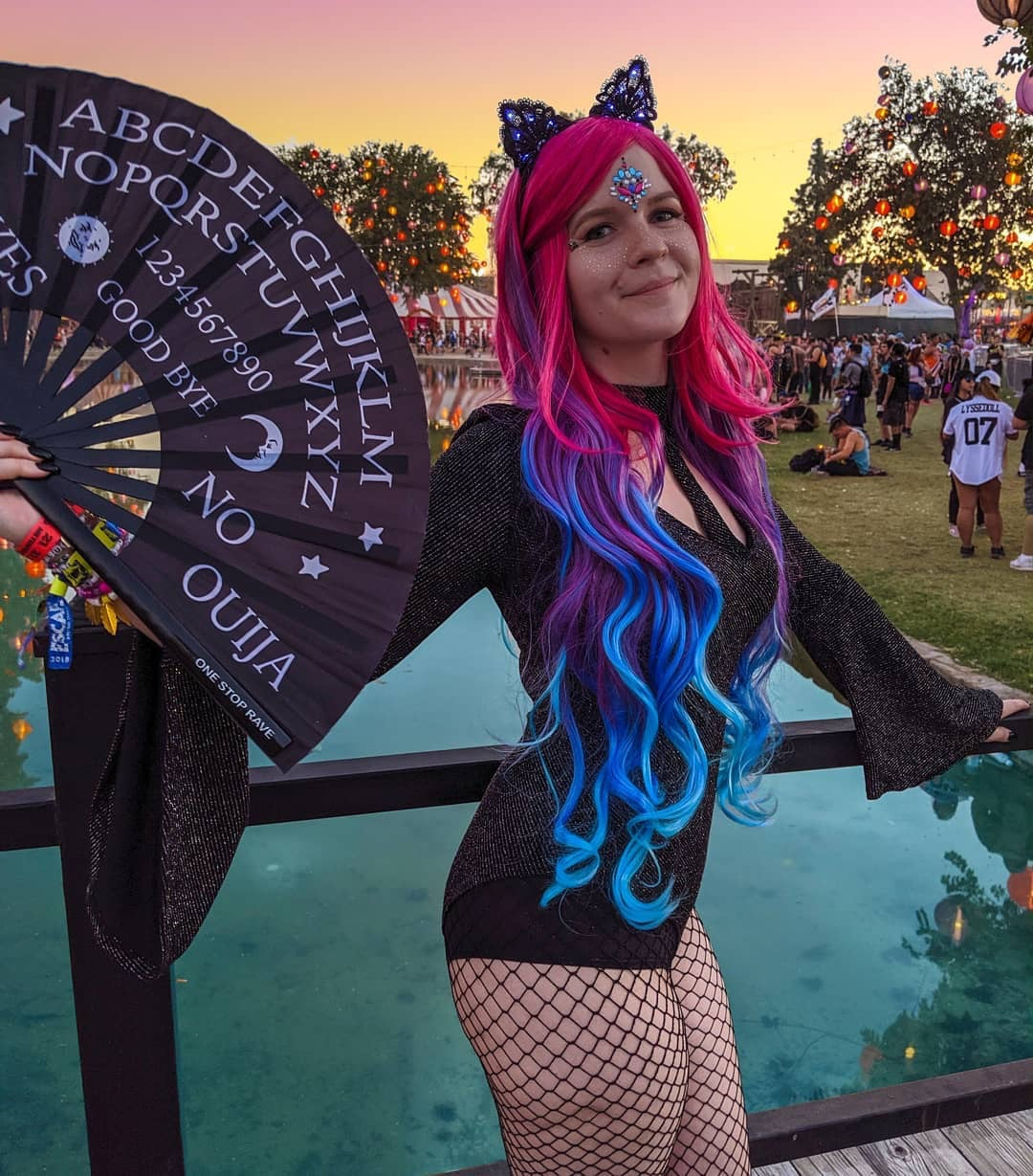 Wake the Dead hand fan held by woman in gothic festival outfit at Escape Halloween