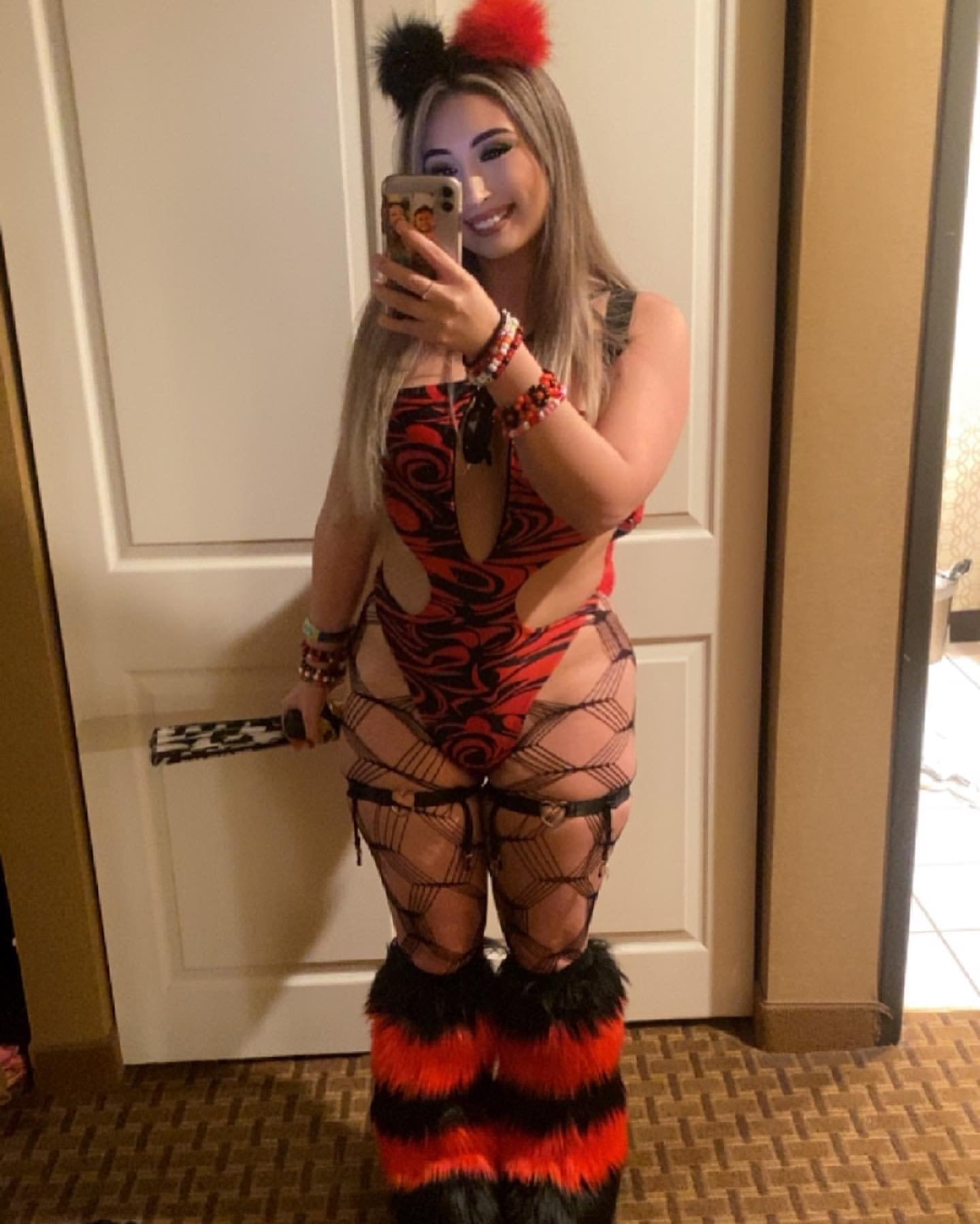 Model wearing black and red faux fur Space Bunz hair clips with matching rave outfit and furry leg warmers.