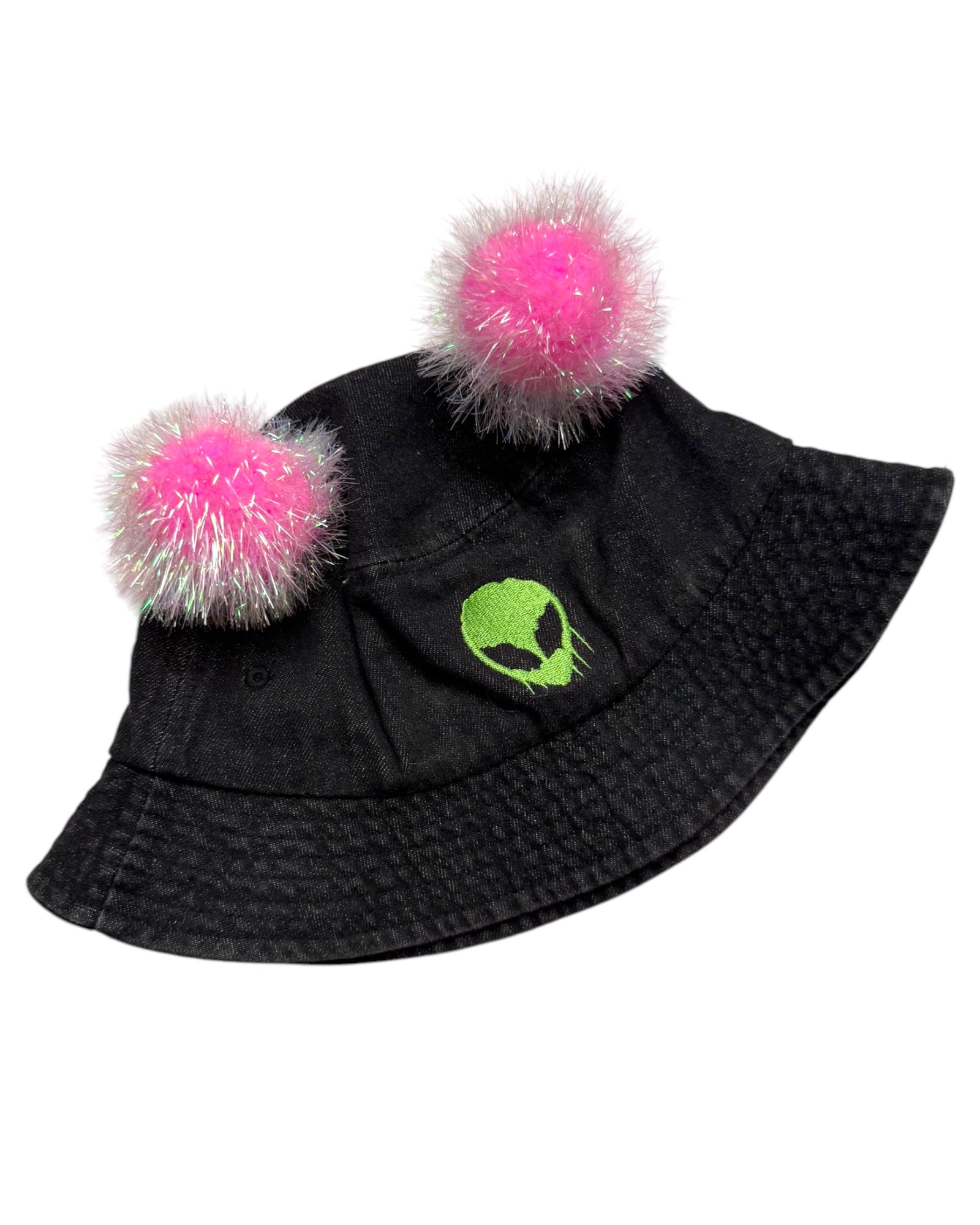 A black bucket hat with pink tinsel pom poms and a green skull logo, designed for music festivals and raves.