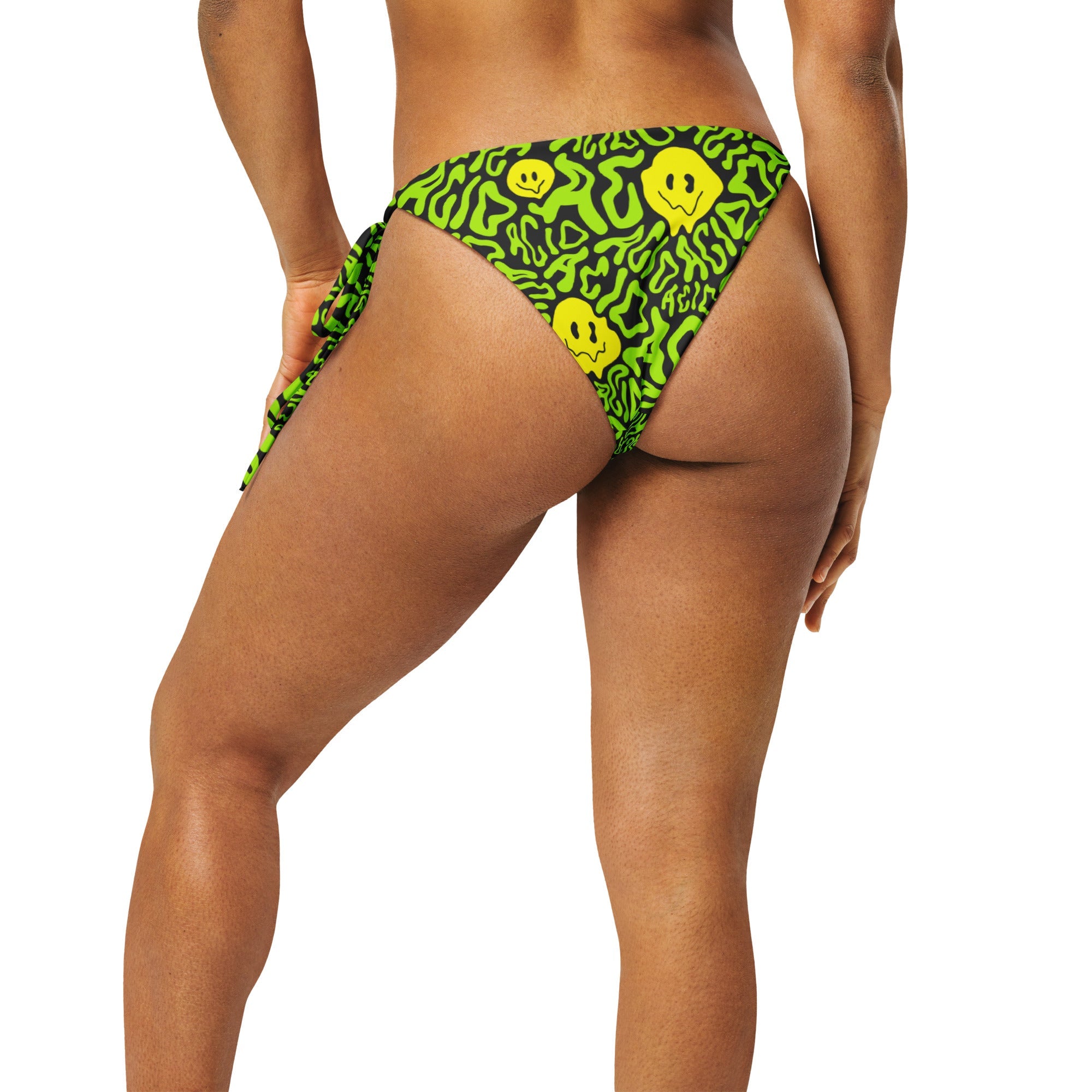 Model showing off the back of the Acid Smilez String Bottoms by One Stop Rave.
