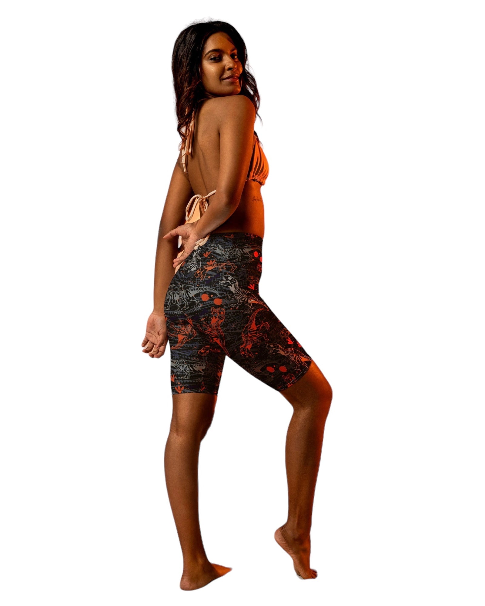 Model sporting One Stop Rave's T-Wrecked Biker Shorts with a vibrant dinosaur print.
