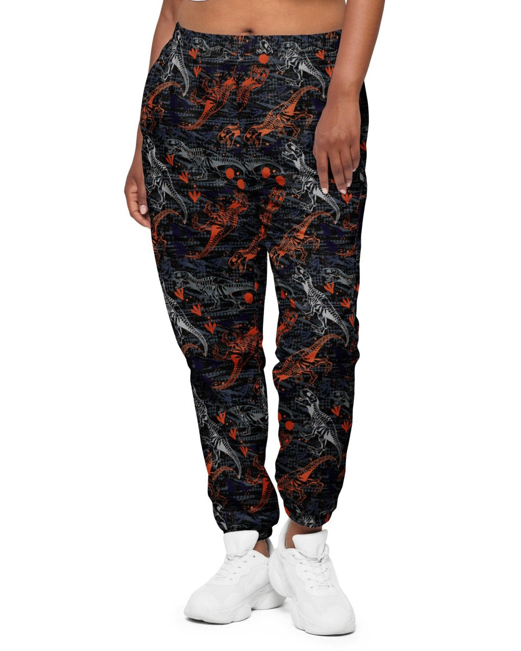 Front view of model wearing One Stop Rave's T-Wrecked Unisex Track Pants, showing off the dynamic dinosaur print.