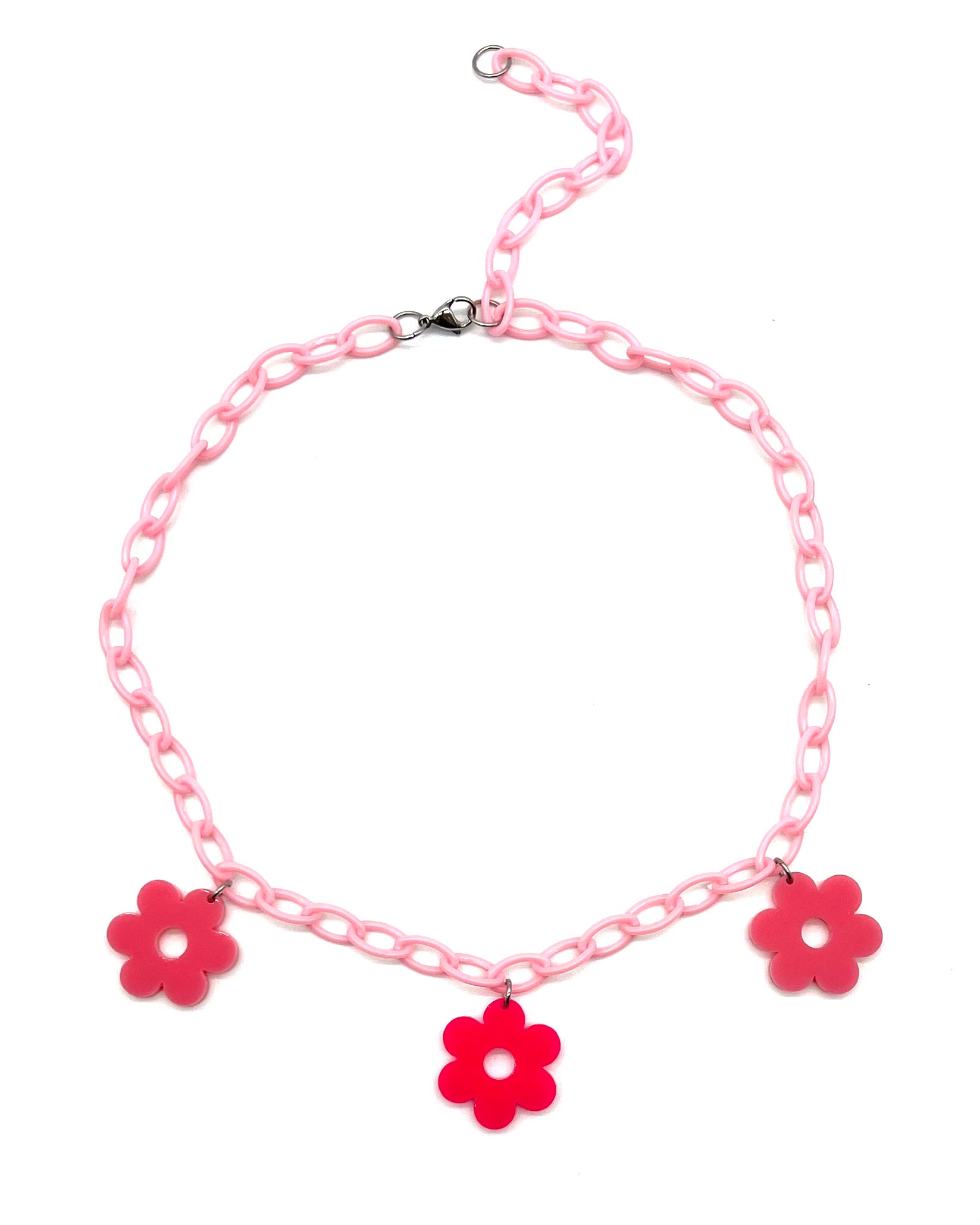 The Flower Power Pink Choker featuring a light pink plastic chain with three alternating light and dark pink daisy charms.
