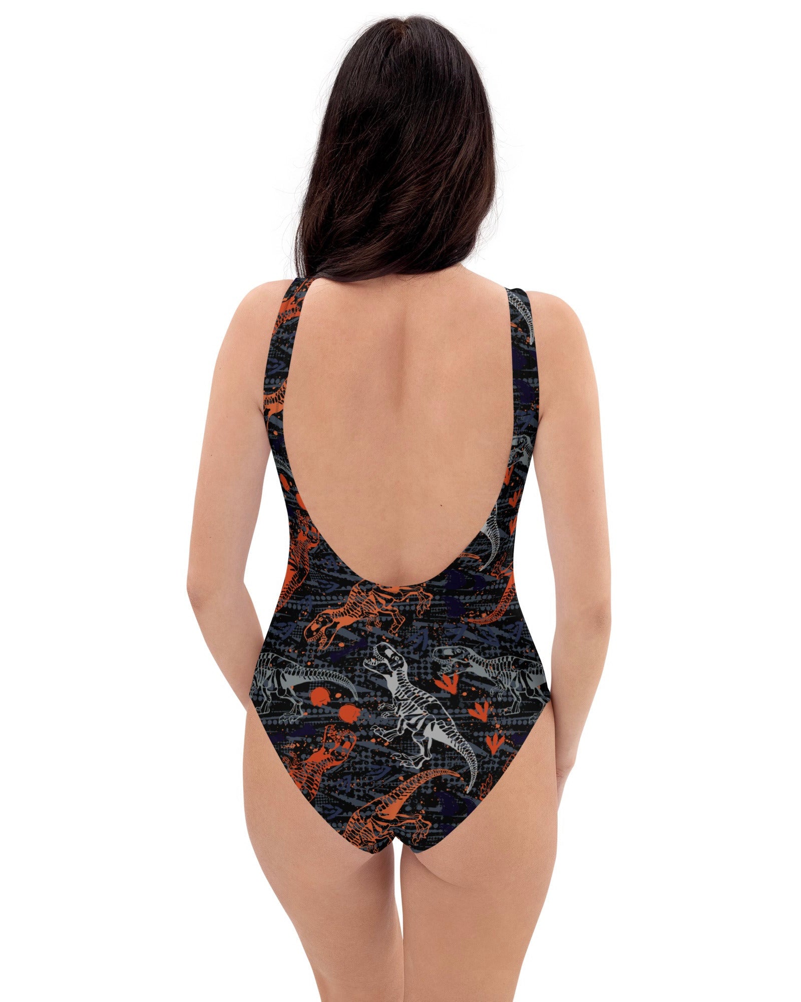Rear  view of model rocking One Stop Rave's T-Wrecked Bodysuit with a dynamic dinosaur print.