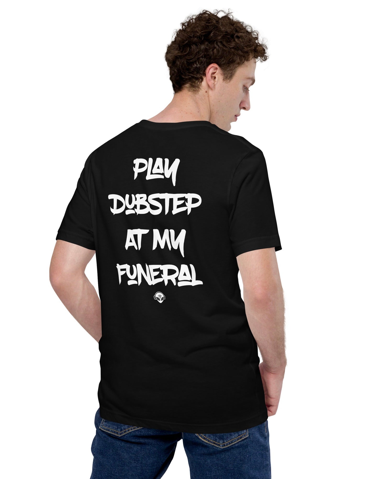 The back side of the model wearing a black t-shirt with the phrase "PLAY DUBSTEP AT MY FUNERAL" & an alien head below it.