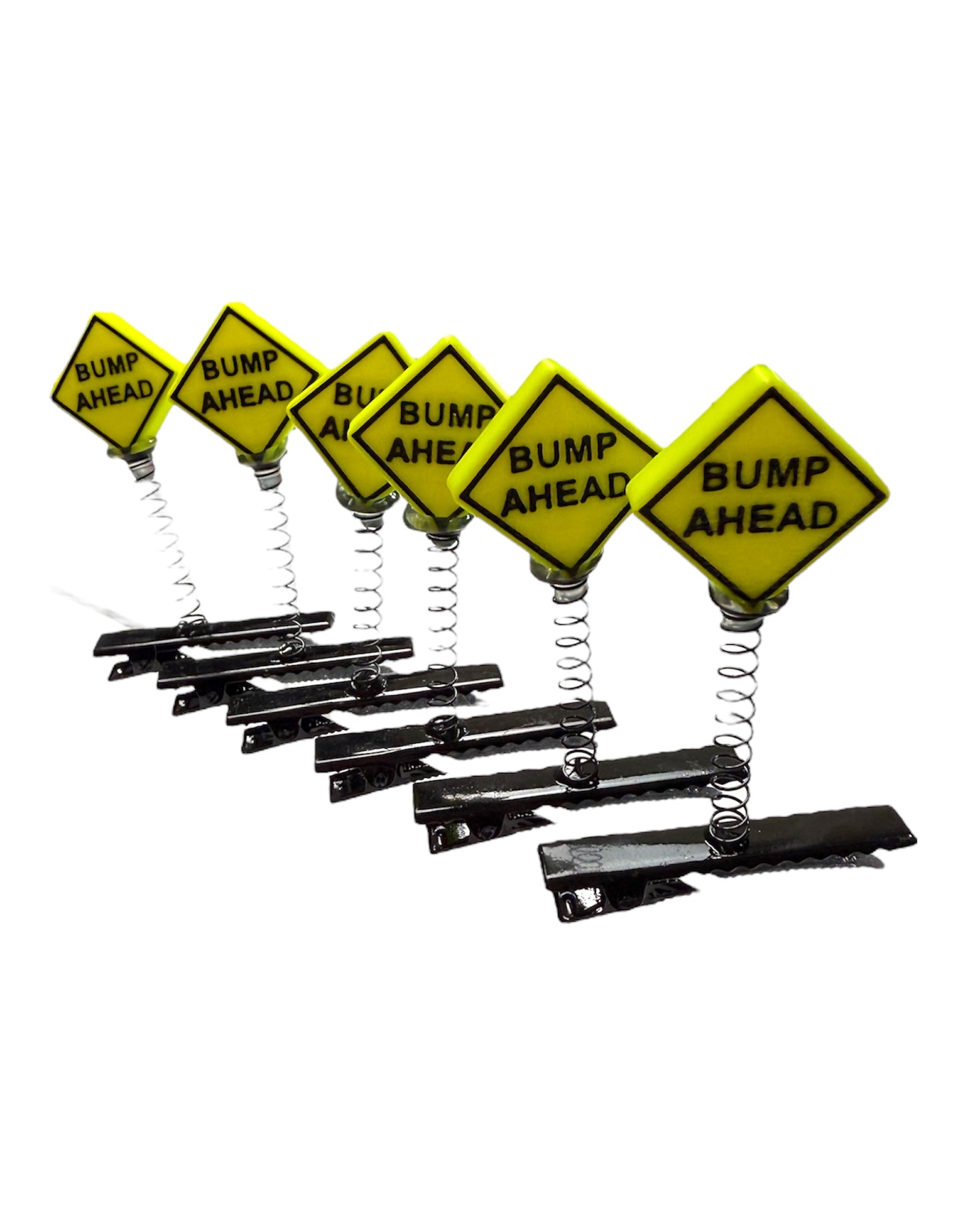 Yellow 'Bump Ahead' signs with black text on a white background
