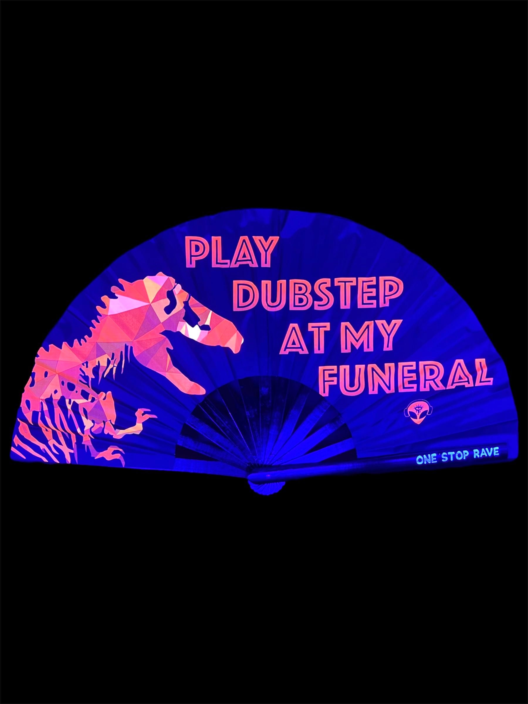 Play Dubstep At My Funeral hand fan glowing under UV blacklight, showing reactive T-Rex print